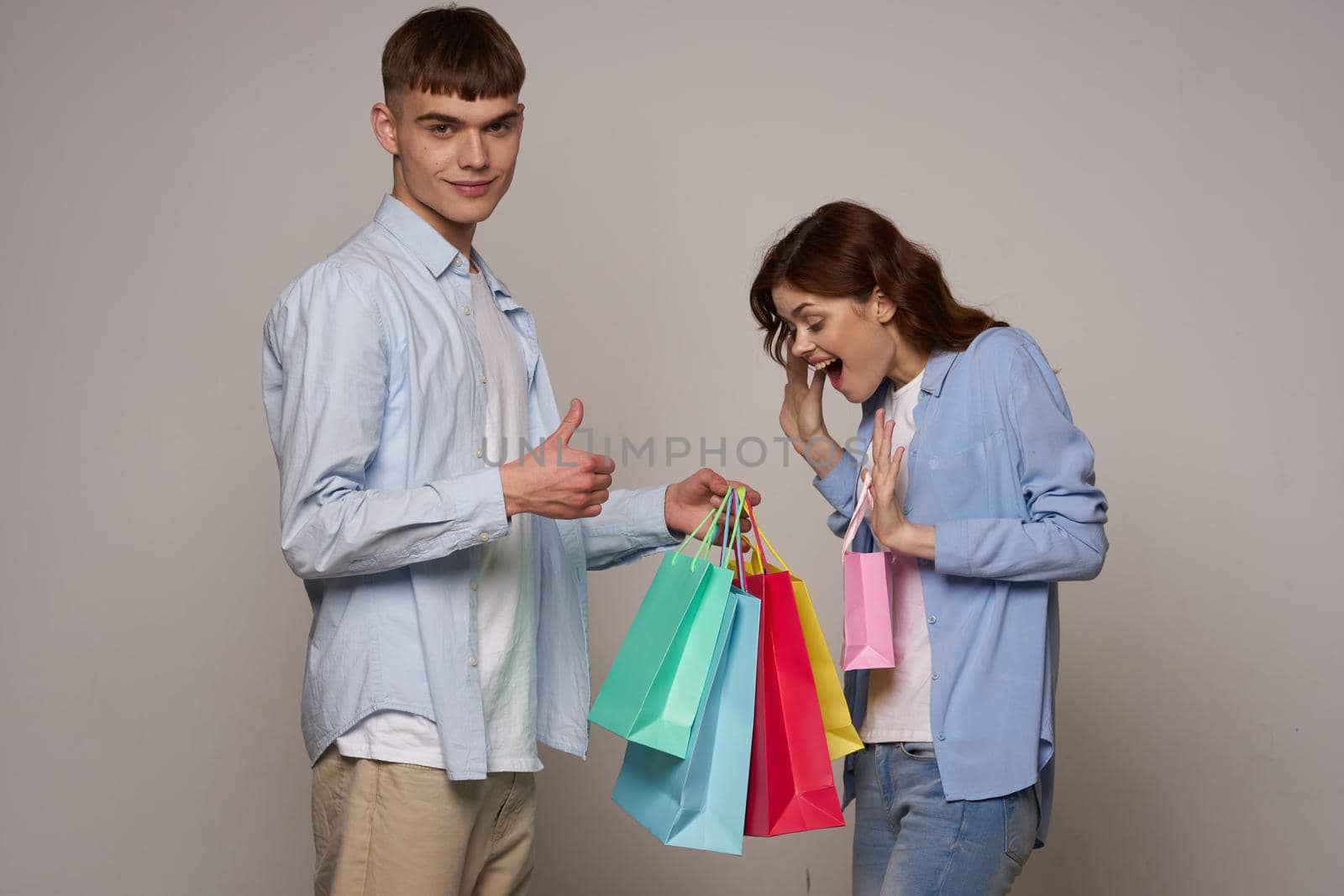 young couple with shopping bags fashion studio by Vichizh