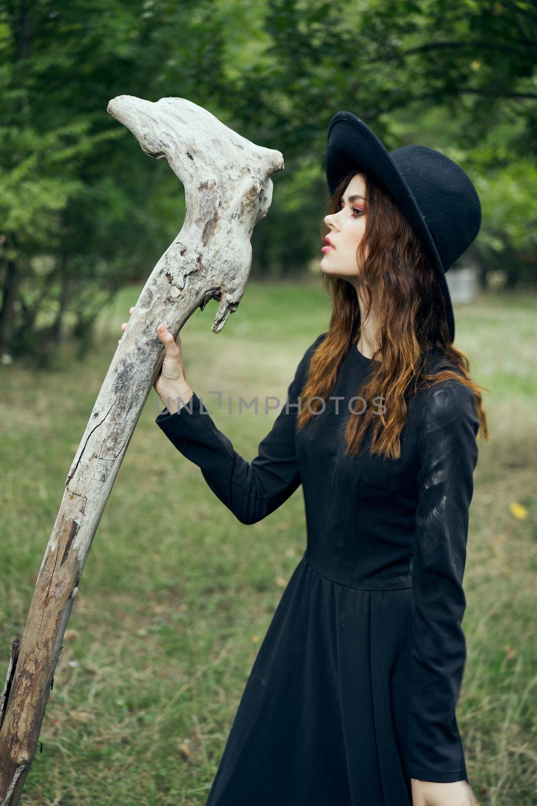 woman in witch costume fantasy magic forest posing. High quality photo