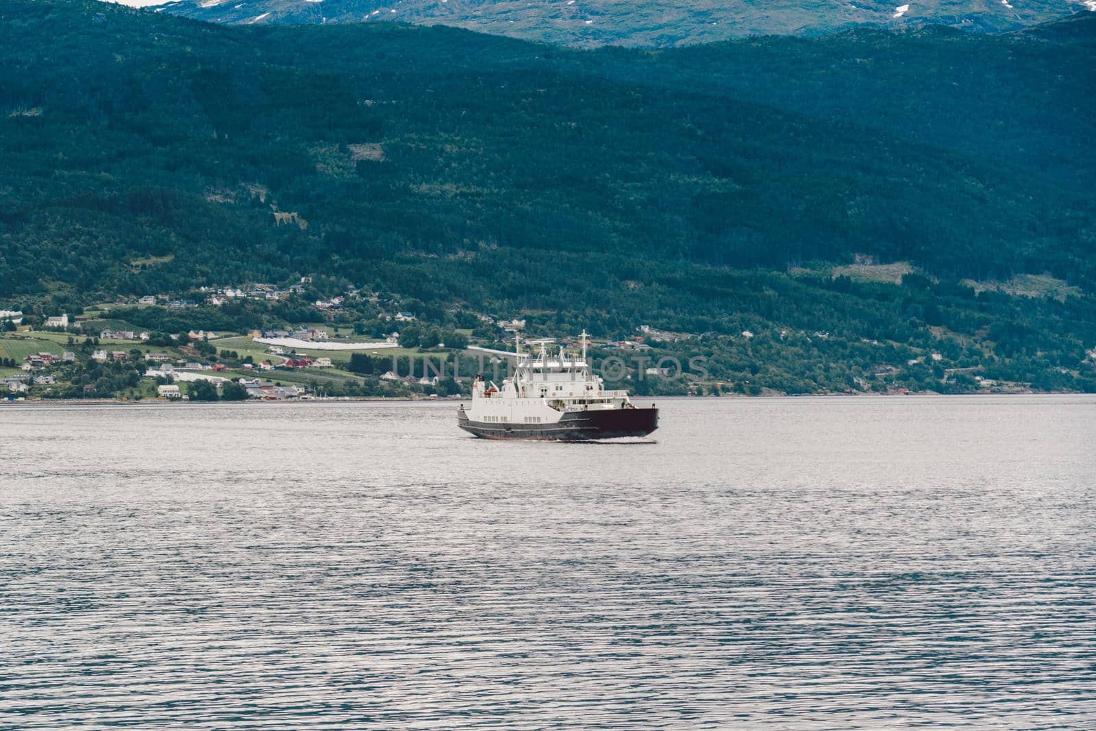 Ferry boat transportation Norway. White passenger ferry goes on fjord. In Norway. ferry crossing a fjord. Ferryboat cruising on Norwegian fjord.