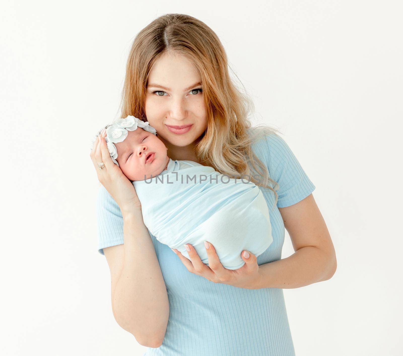 young beautiful mother holding a newborn daughter by tan4ikk1