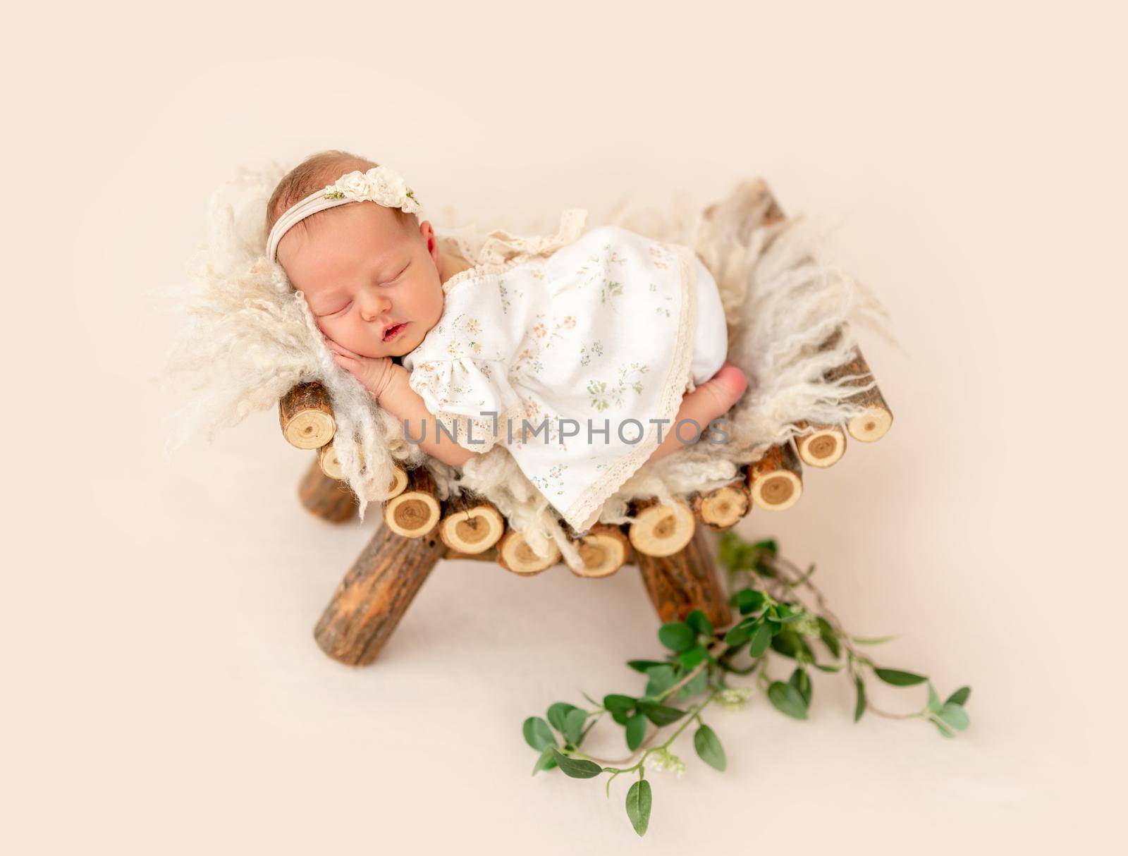 Innocent newborn baby sleeping comfortable on pedestal