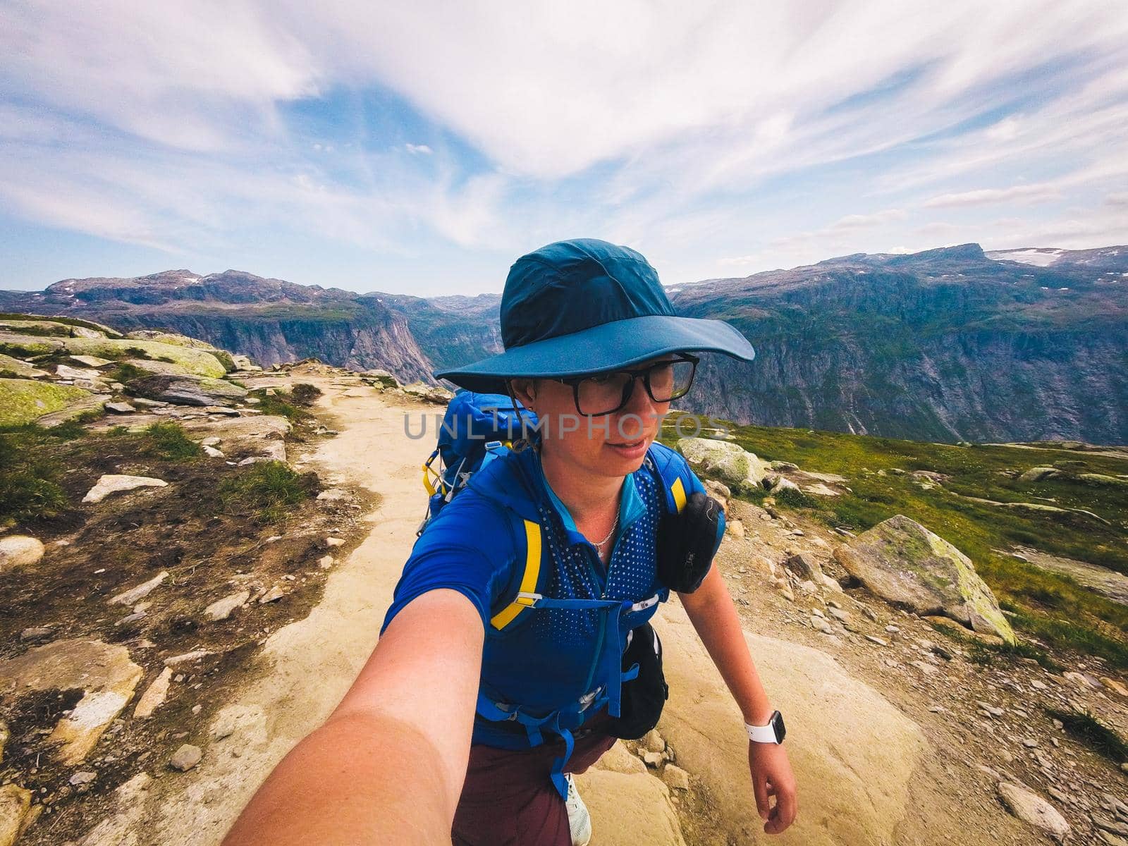 Handsome adventurous human taking selfie mountain. Woman traveler photo yourself action camera in nature. Travel Lifestyle adventure concept active vacations outdoor, hiking success and healthy life by Tomashevska
