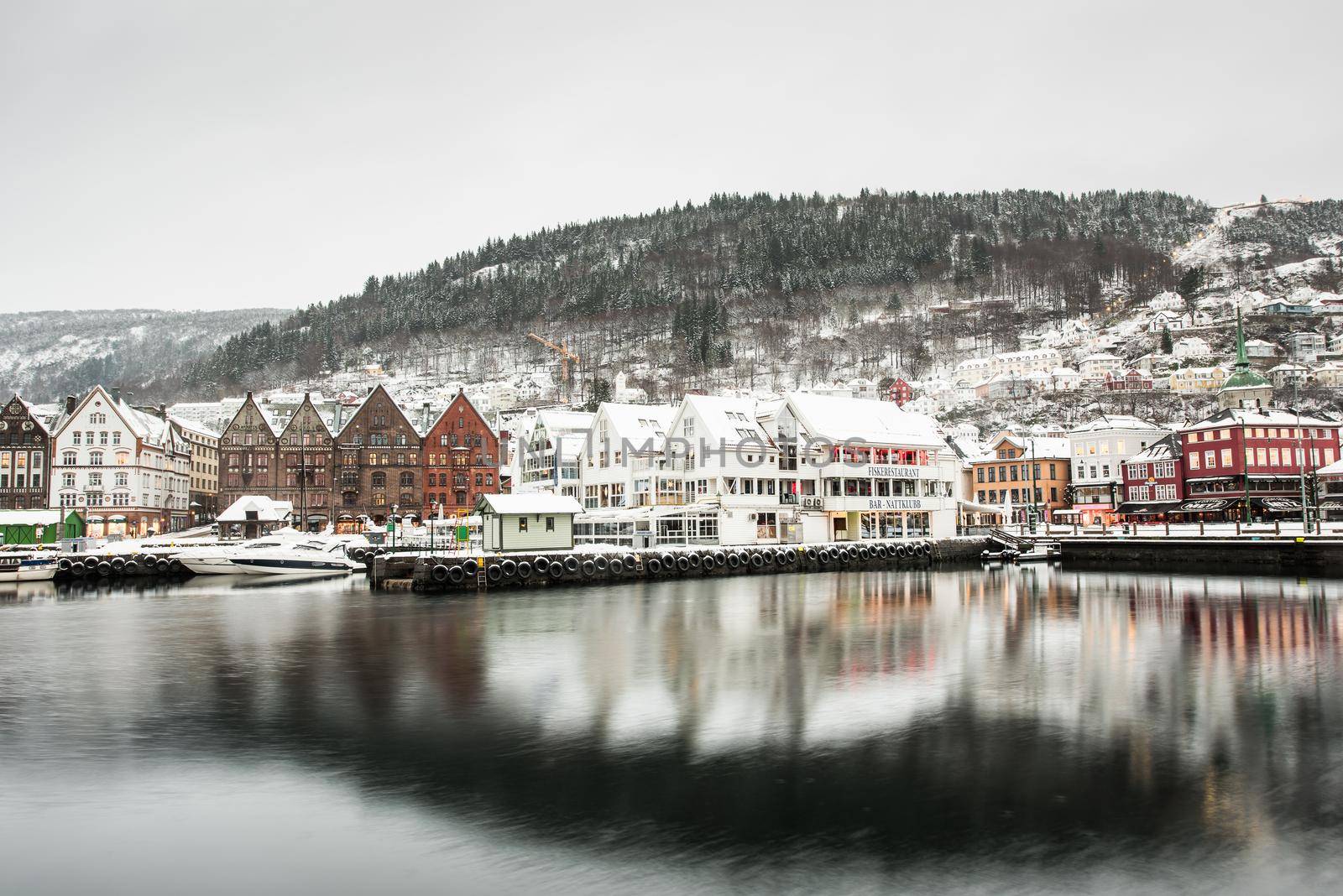 Bergen, Norway - December 29, 2014: Famous Bryggen street with wooden colored houses in Bergen at Christmas, Norway