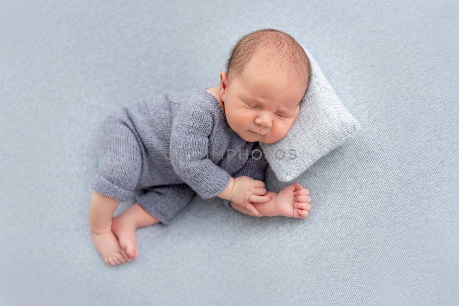 Sweet newborn sleeping on tiny pillow