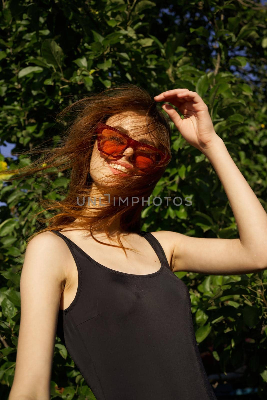 pretty woman wearing sunglasses green leaves summer model. High quality photo