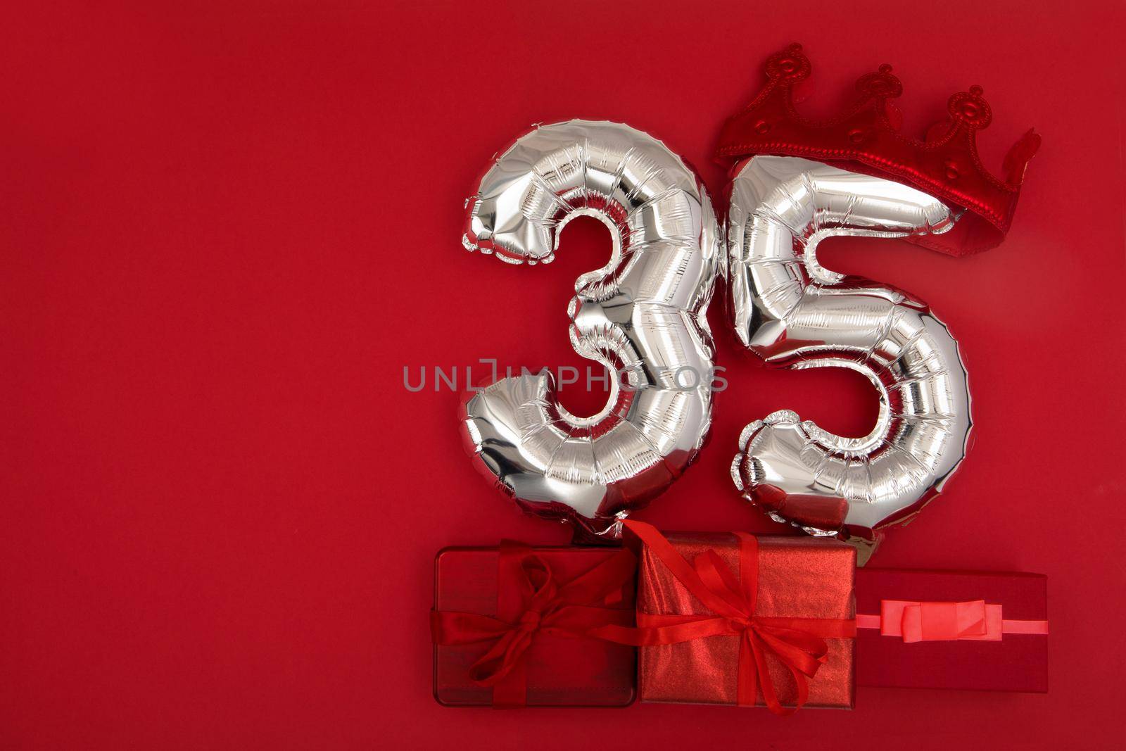 Foil balloons with number 35 on red background by Demkat