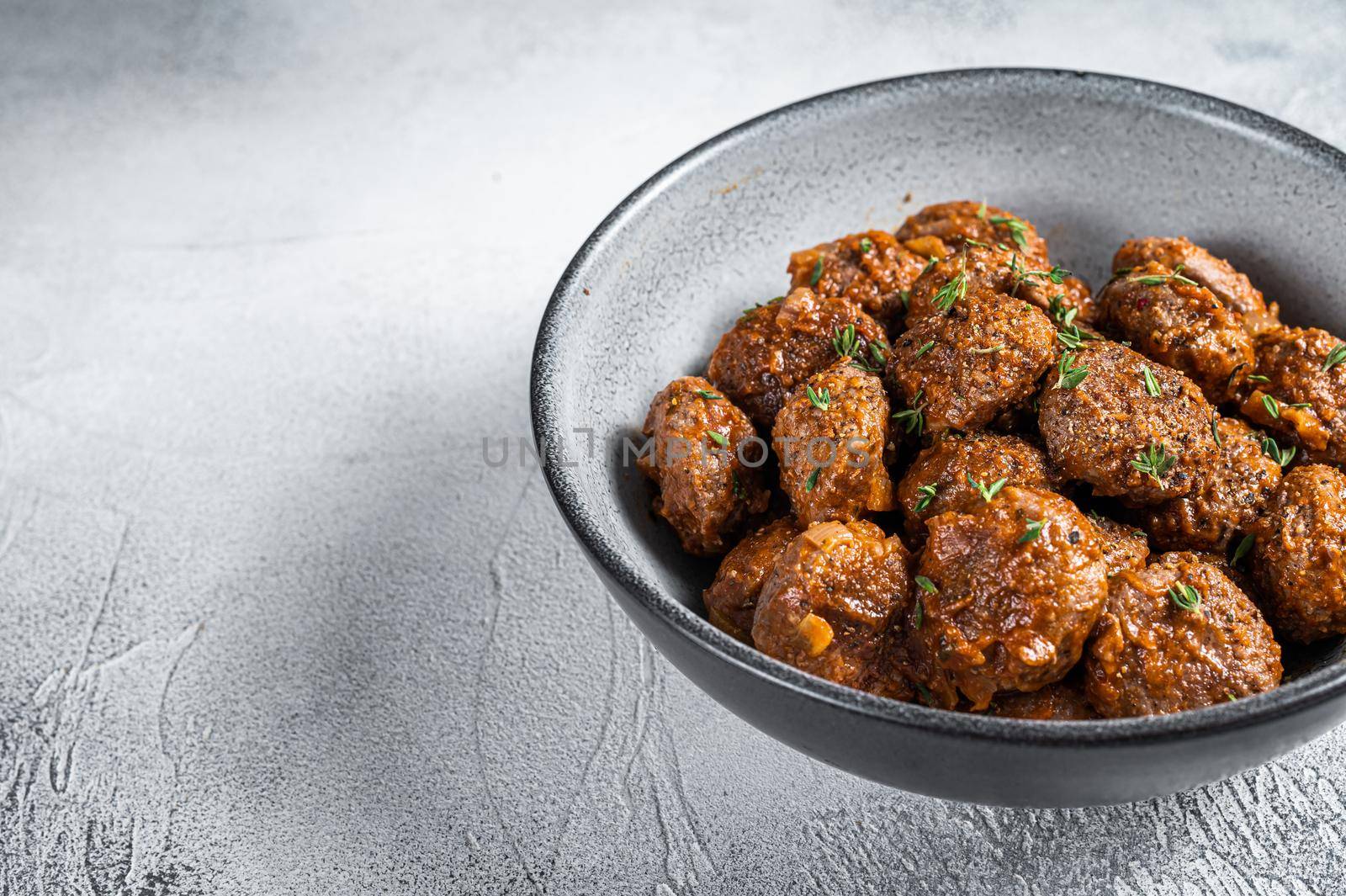 Fried Meatballs in tomato sauce from ground beef and pork meat. White background. Top view. Copy space.