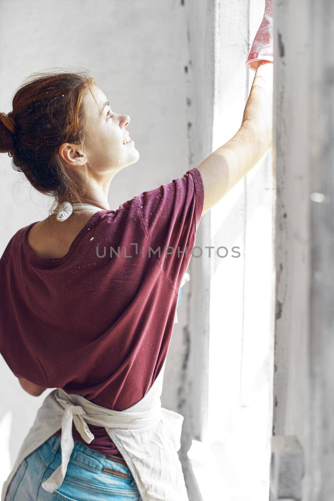 woman paints the window in the room interior renovation decoration. High quality photo