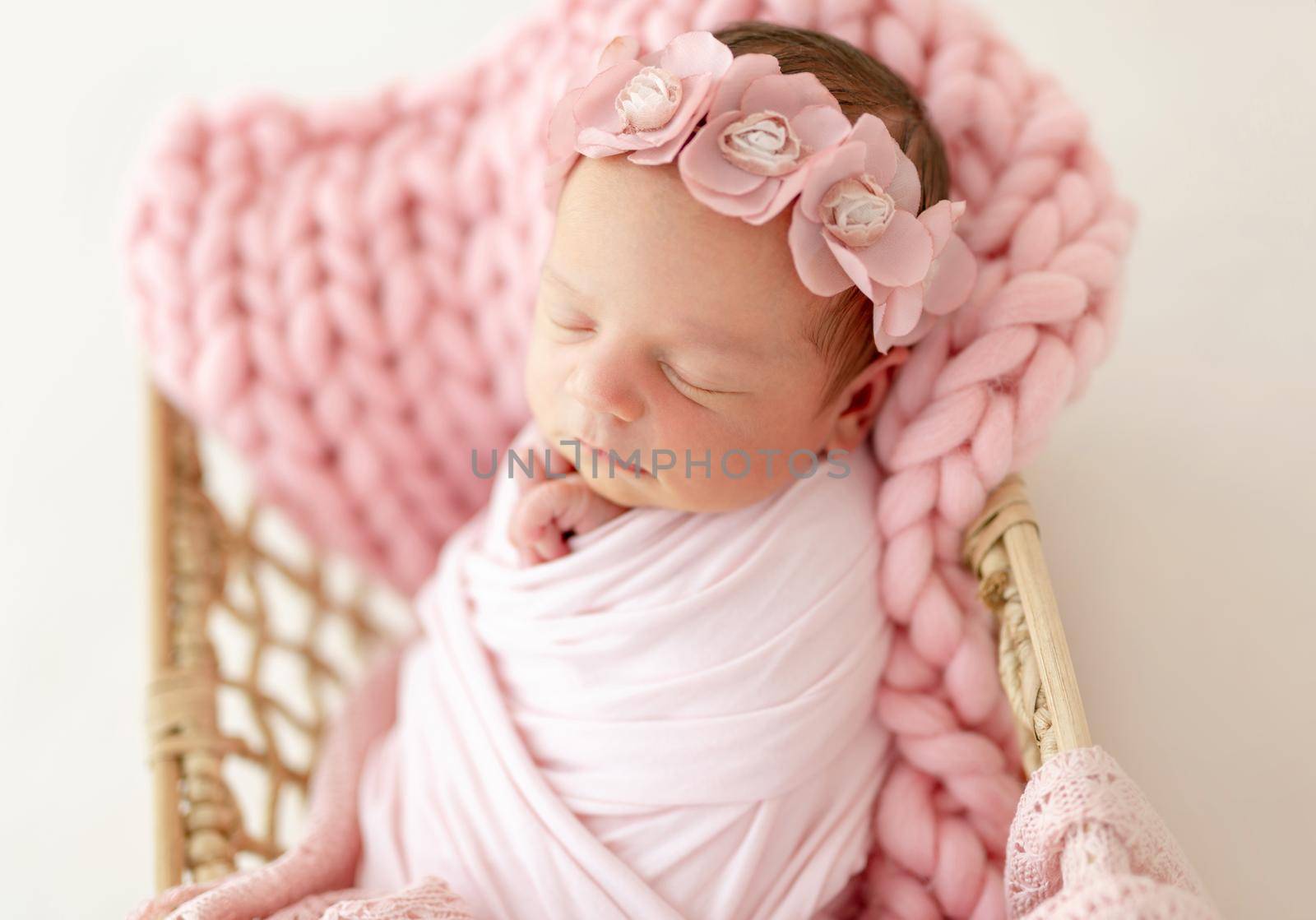 newborn baby girl sleeping sweetly in the basket