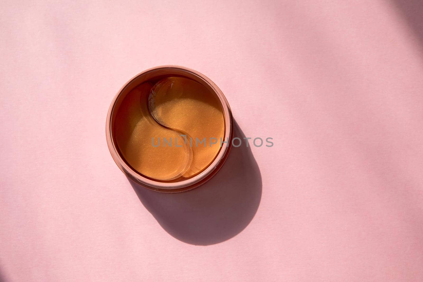 Eye patch packaging on pink background. Pink hydrogel eye patches Bathroom treatments. Homemade face care