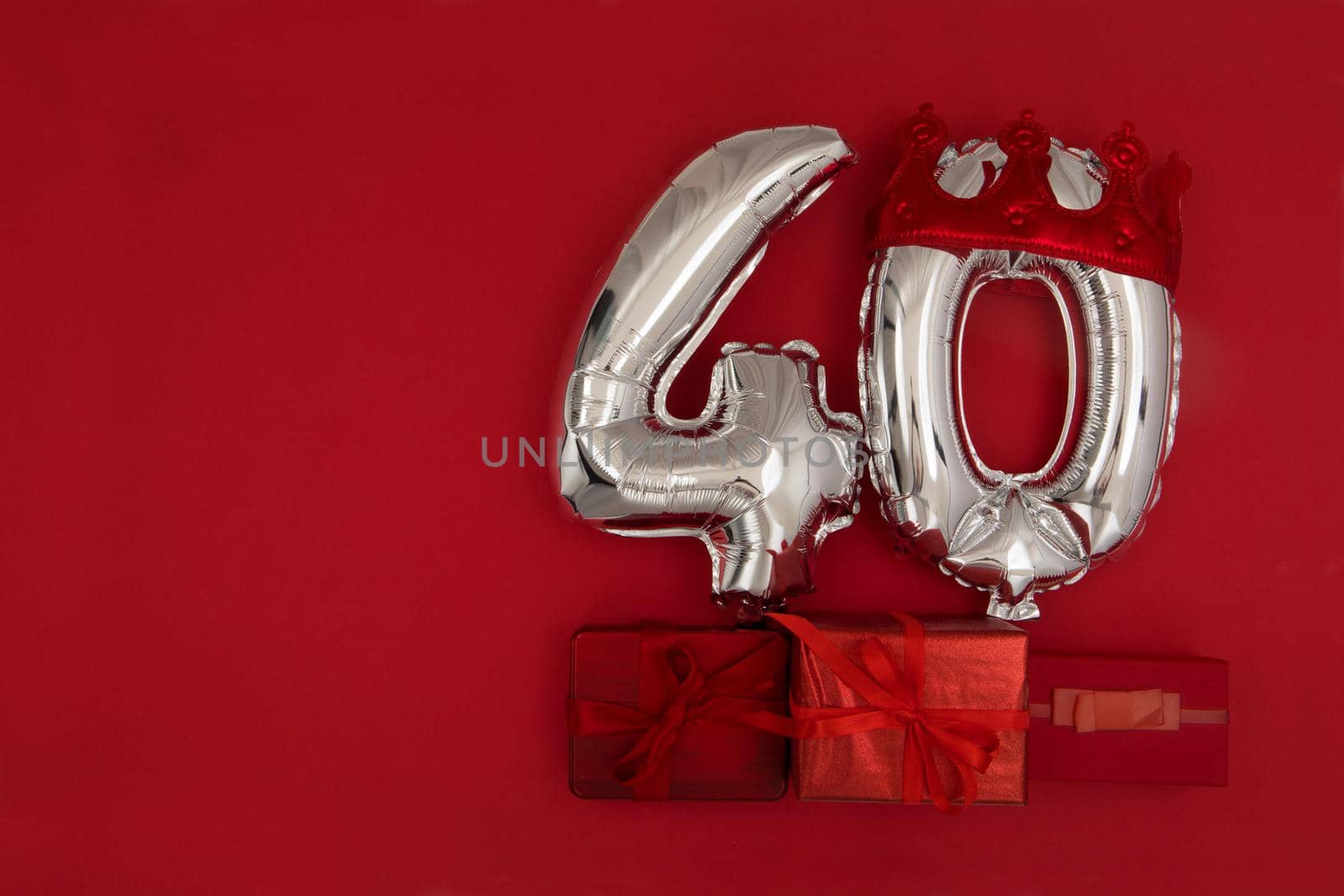 Silver Number Balloons 40 forty in crown on dark red background. Holiday Party Decoration, 40 postcard concept with top view