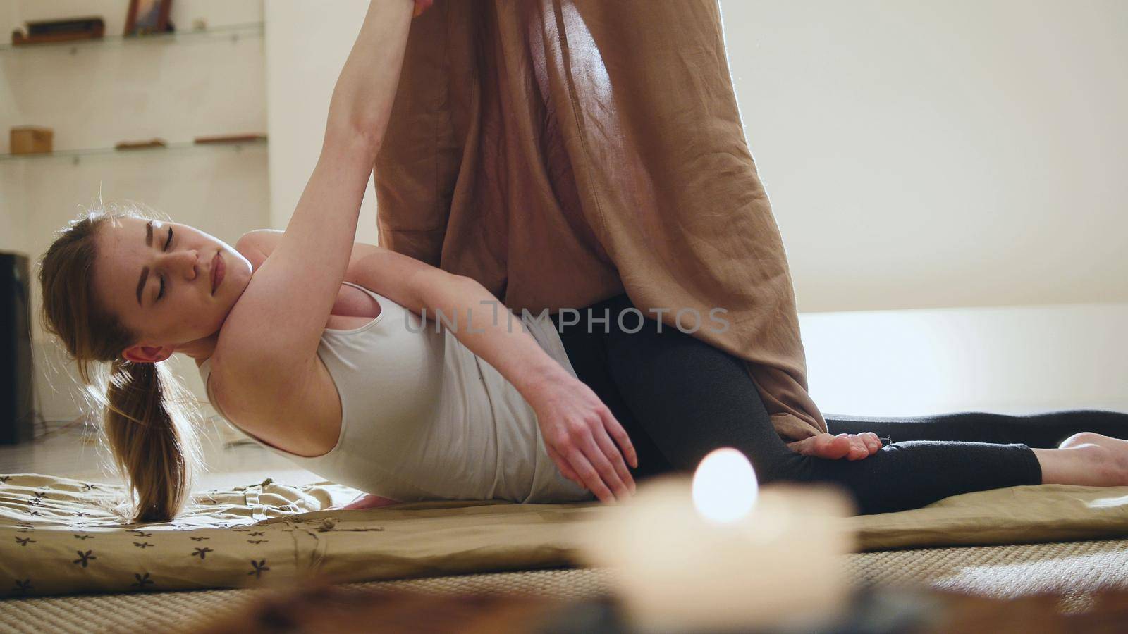Traditional thailand massage therapy - impact on hands of caucasian female, telephoto