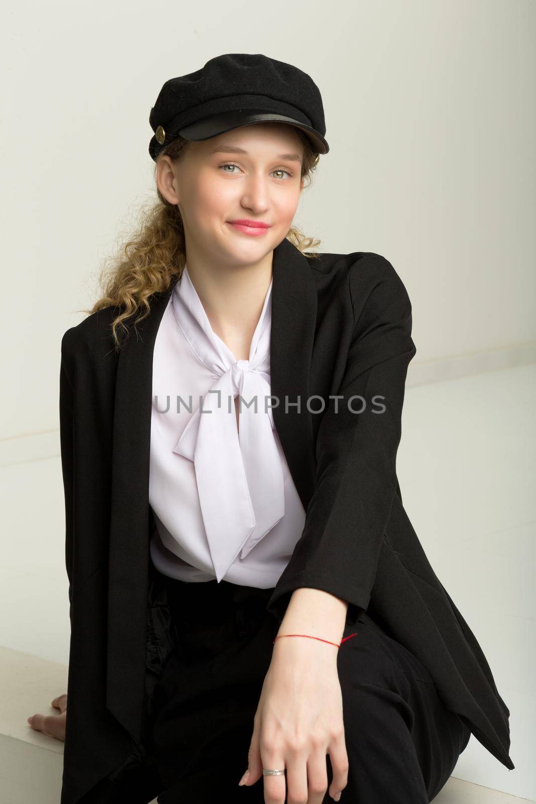Portrait of cheerful girl in elegant suit and cap by kolesnikov_studio