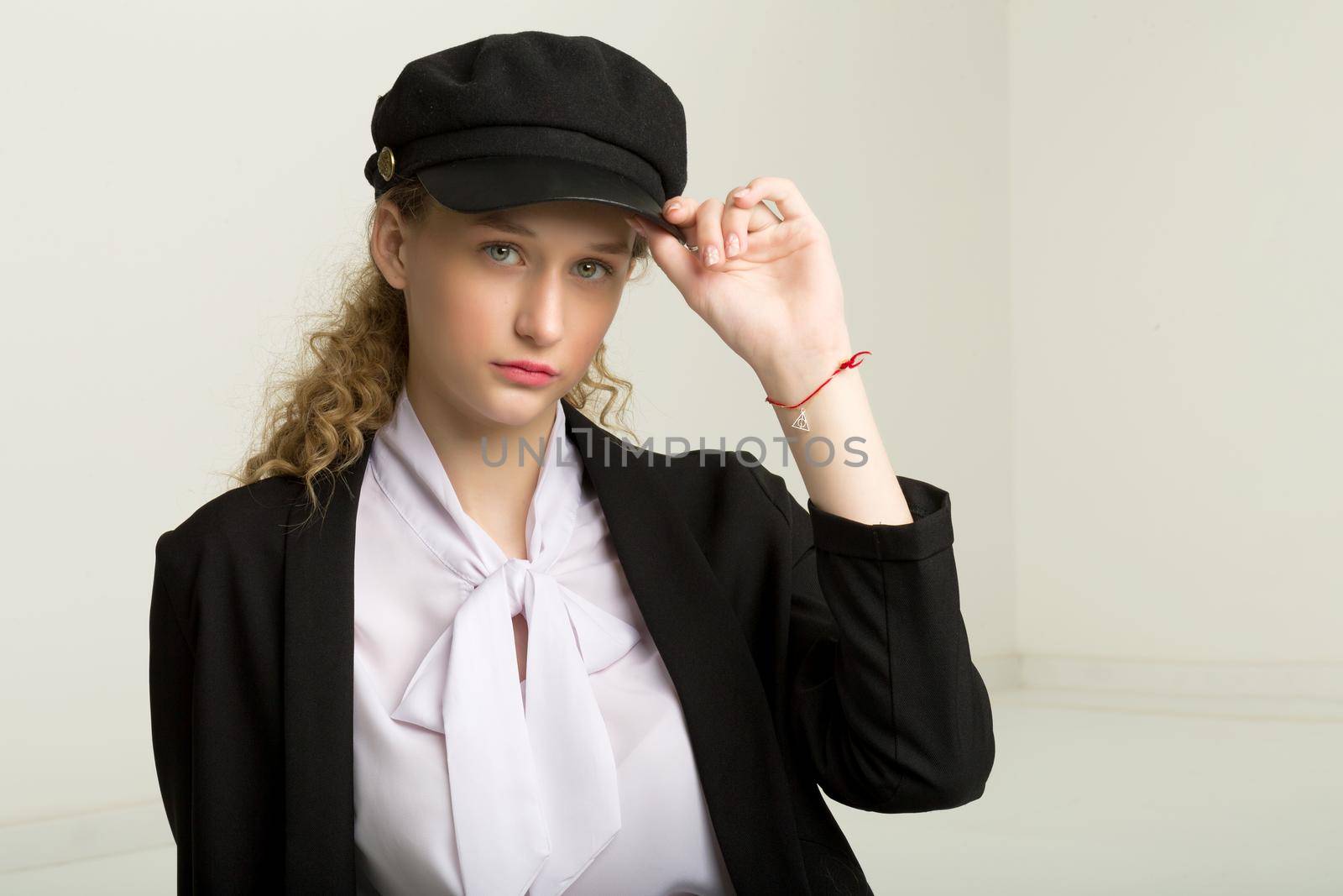 Portrait of pretty girl in black suit and cap by kolesnikov_studio