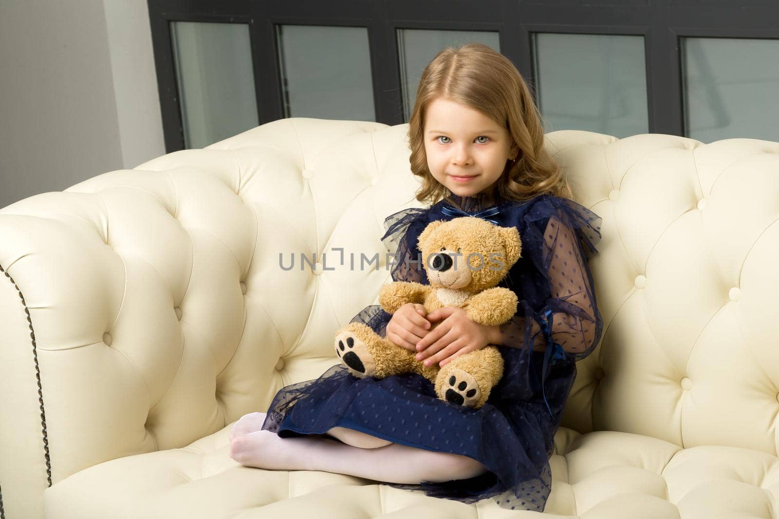 Lovely little girl hugging her teddy bear toy by kolesnikov_studio