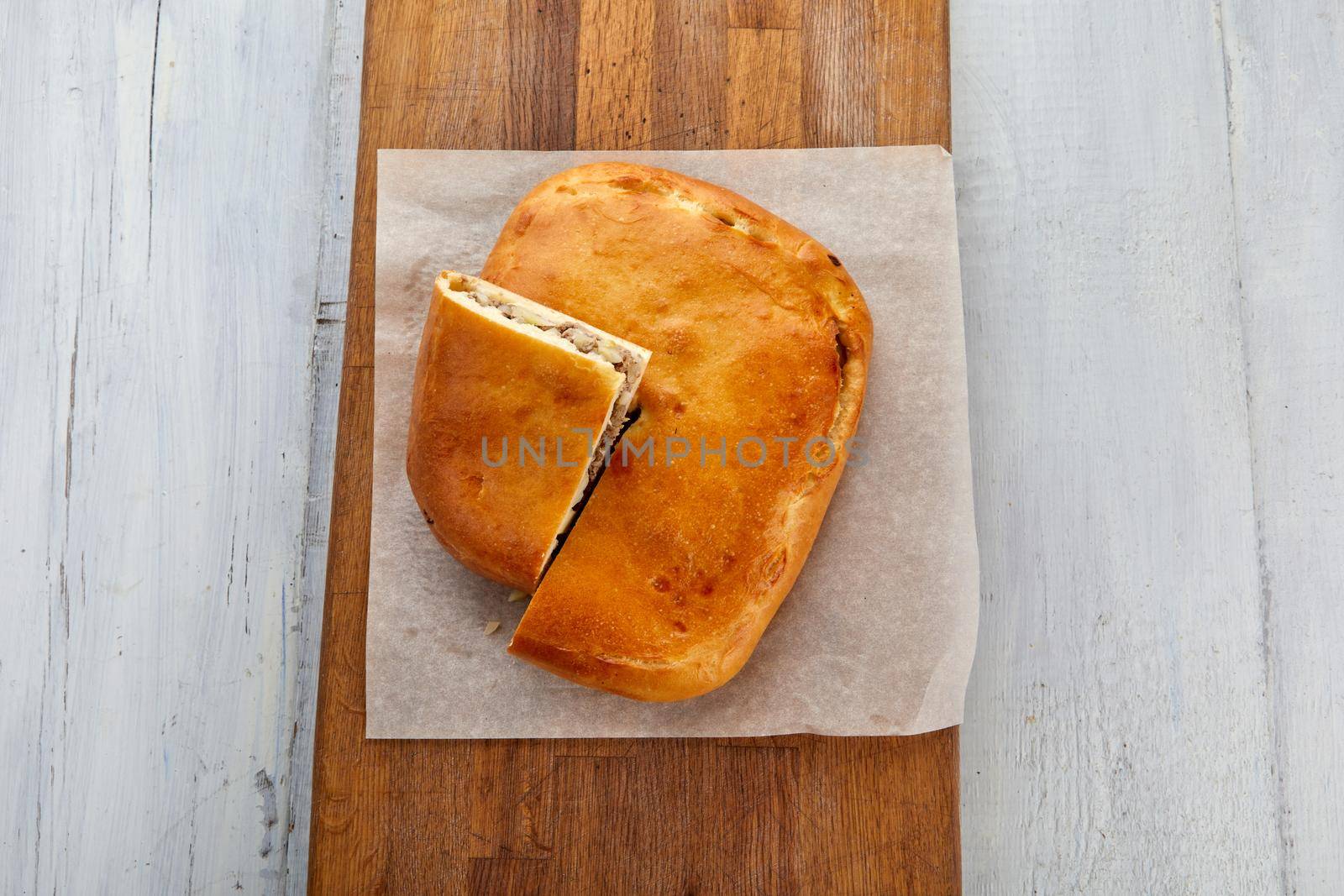 Meat pie on cutting board white wood background by Demkat