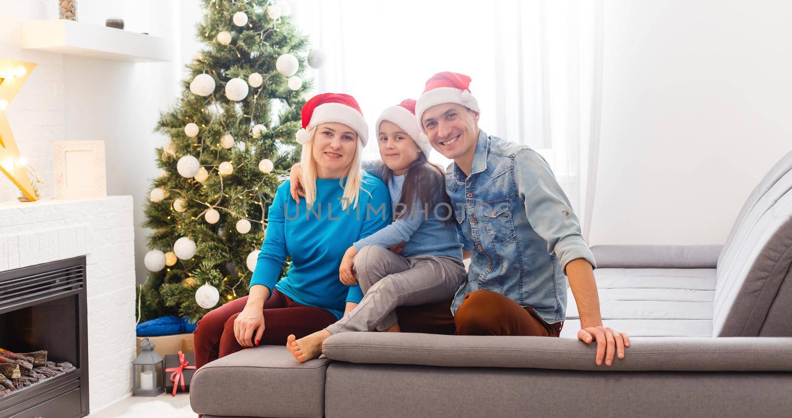 Young family on Christmas morning exchanging presents and enjoying their time together.