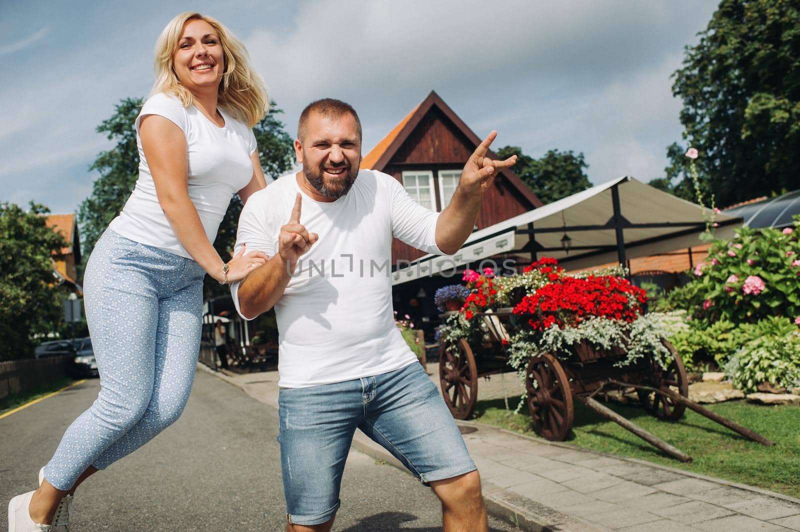 Portrait of a happy couple laughing at the camera in Nida.Happy people.Family.Lithuania by Lobachad