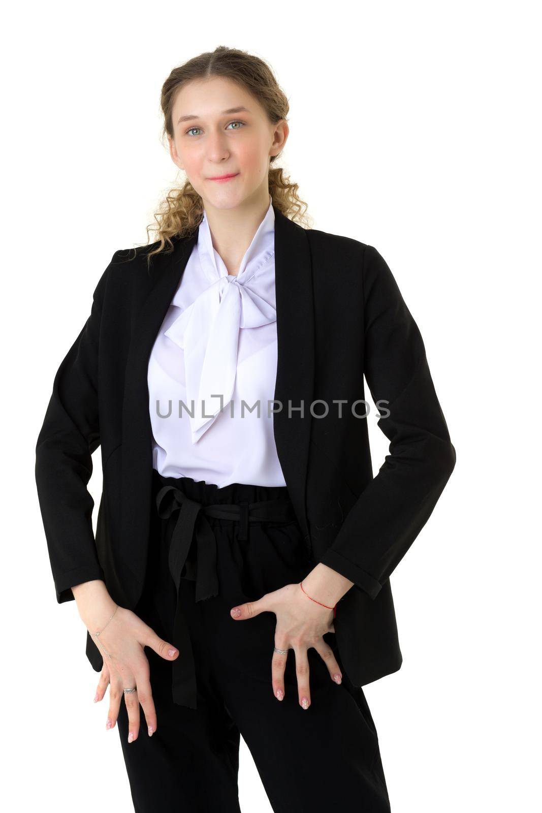 Portrait of a surprised girl in an elegant black suit. Stylish young woman in trendy black suit standing against isolated white background
