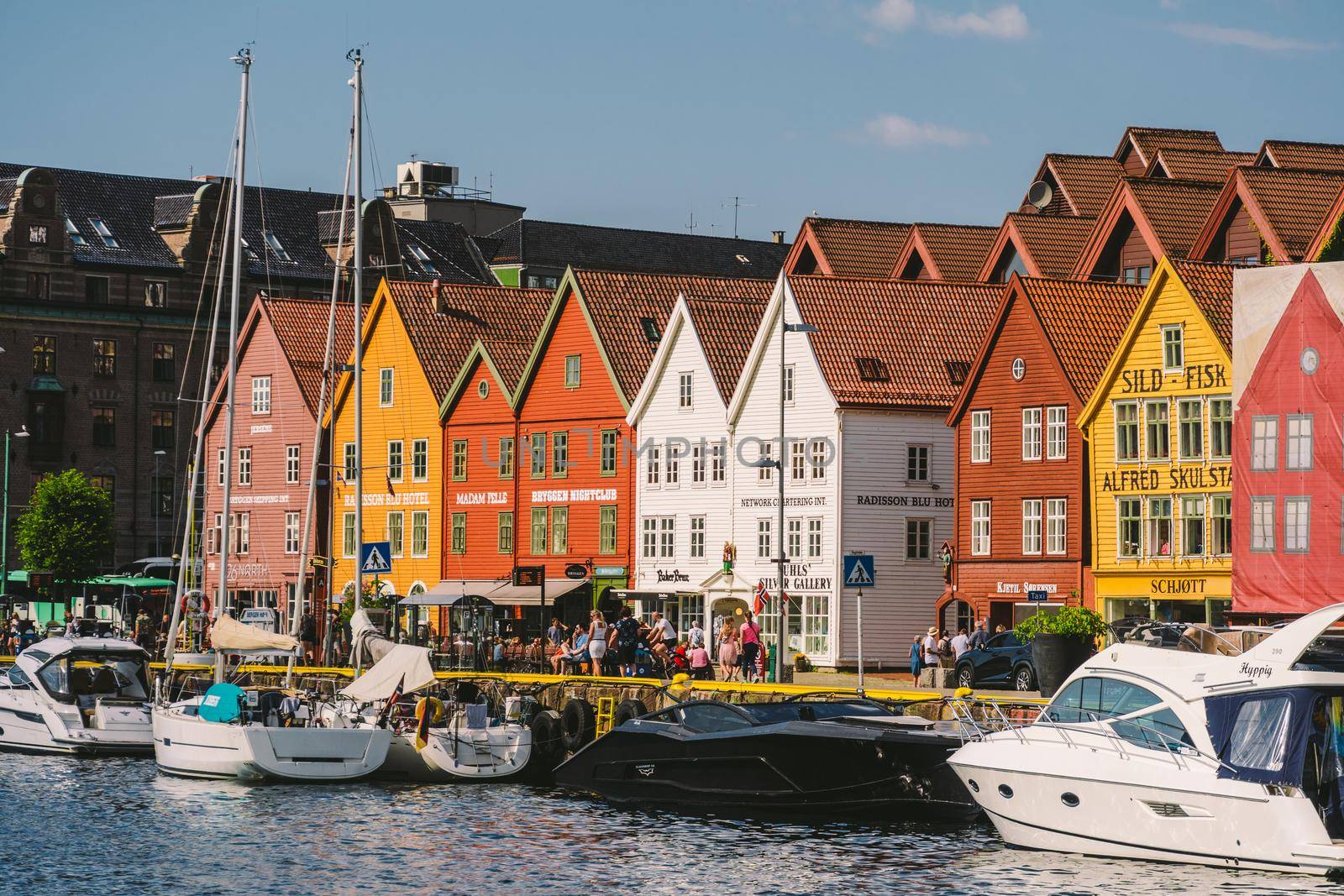 Bergen, Norway. View of historical buildings in Bryggen. Hanseatic wharf in Bergen, Norway July 28, 2019. UNESCO. Famous Bryggen street with wooden colored houses in Bergen Akerbrygge distric by Tomashevska