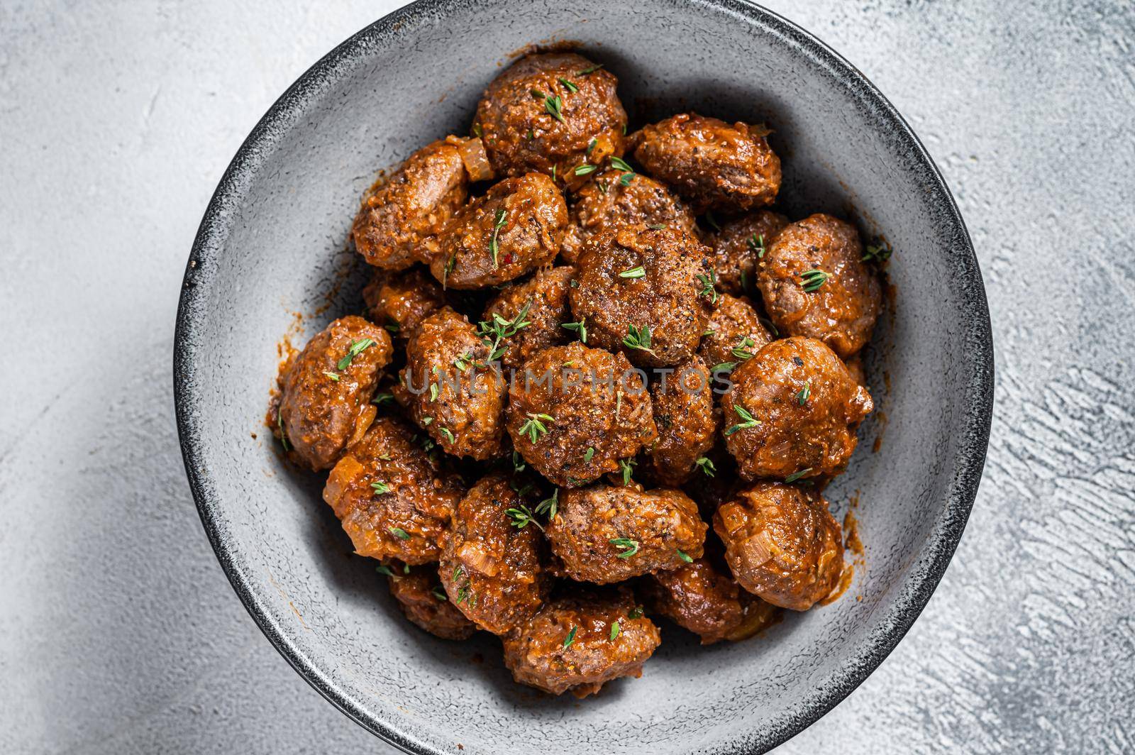 Fried Meatballs in tomato sauce from ground beef and pork meat. White background. Top view.