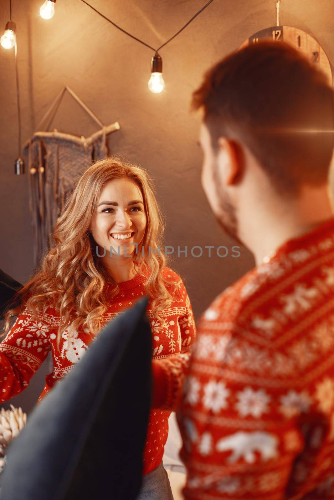 People in a Christman decorations. Man and woman in a red sweater. Family at home.