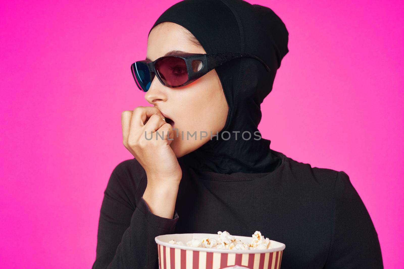 arab woman attractive look popcorn glasses movie watching isolated background. High quality photo