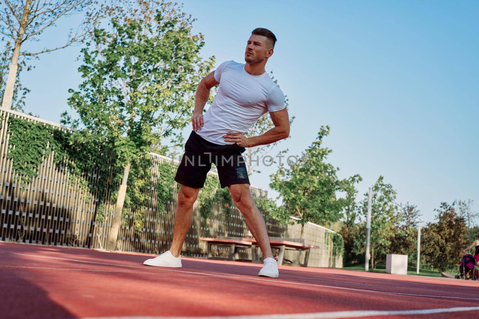 man doing exercises outdoors on the playground by Vichizh