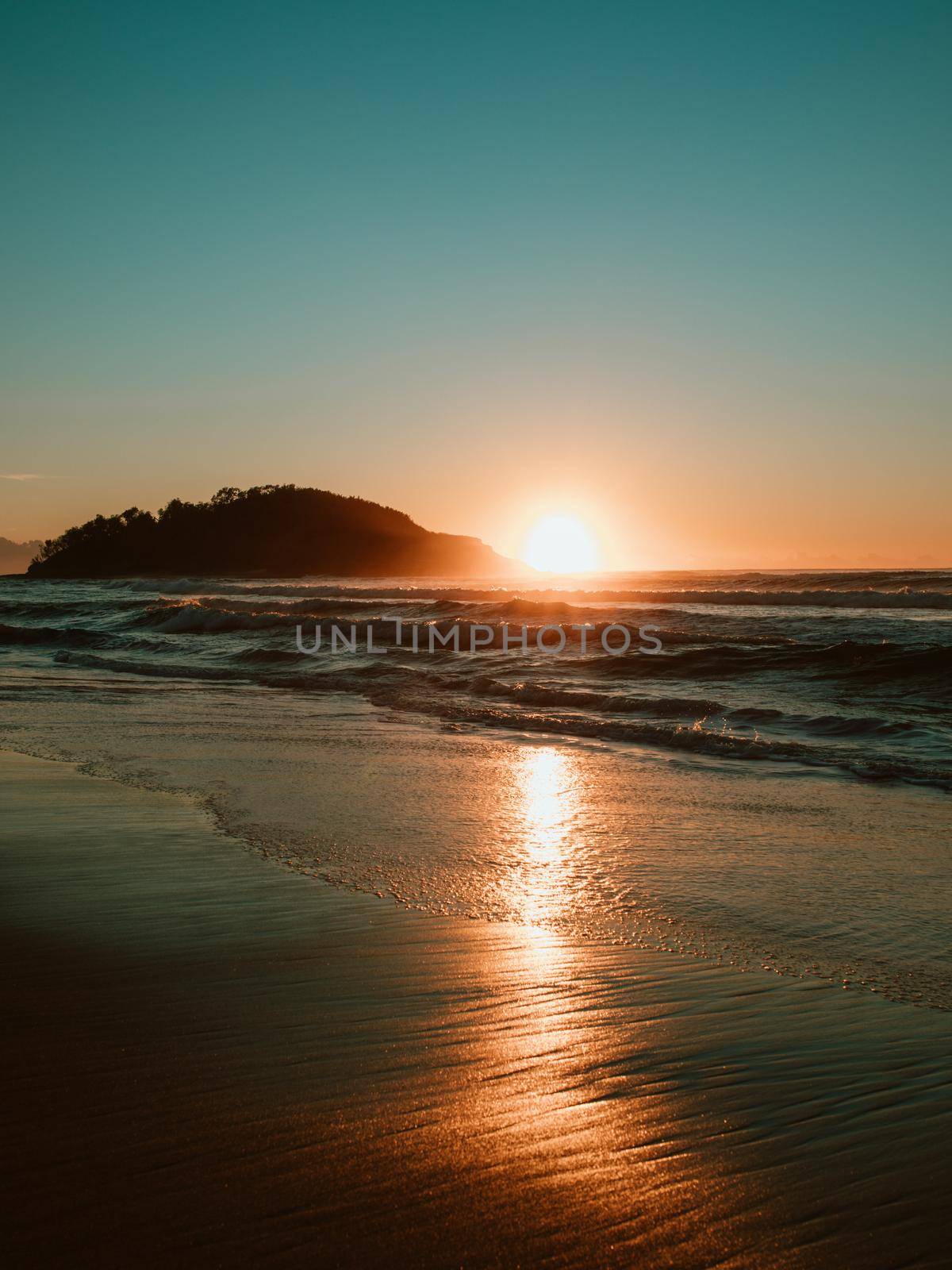 Sunrise on the beach and ocean waves. by braydenstanfordphoto