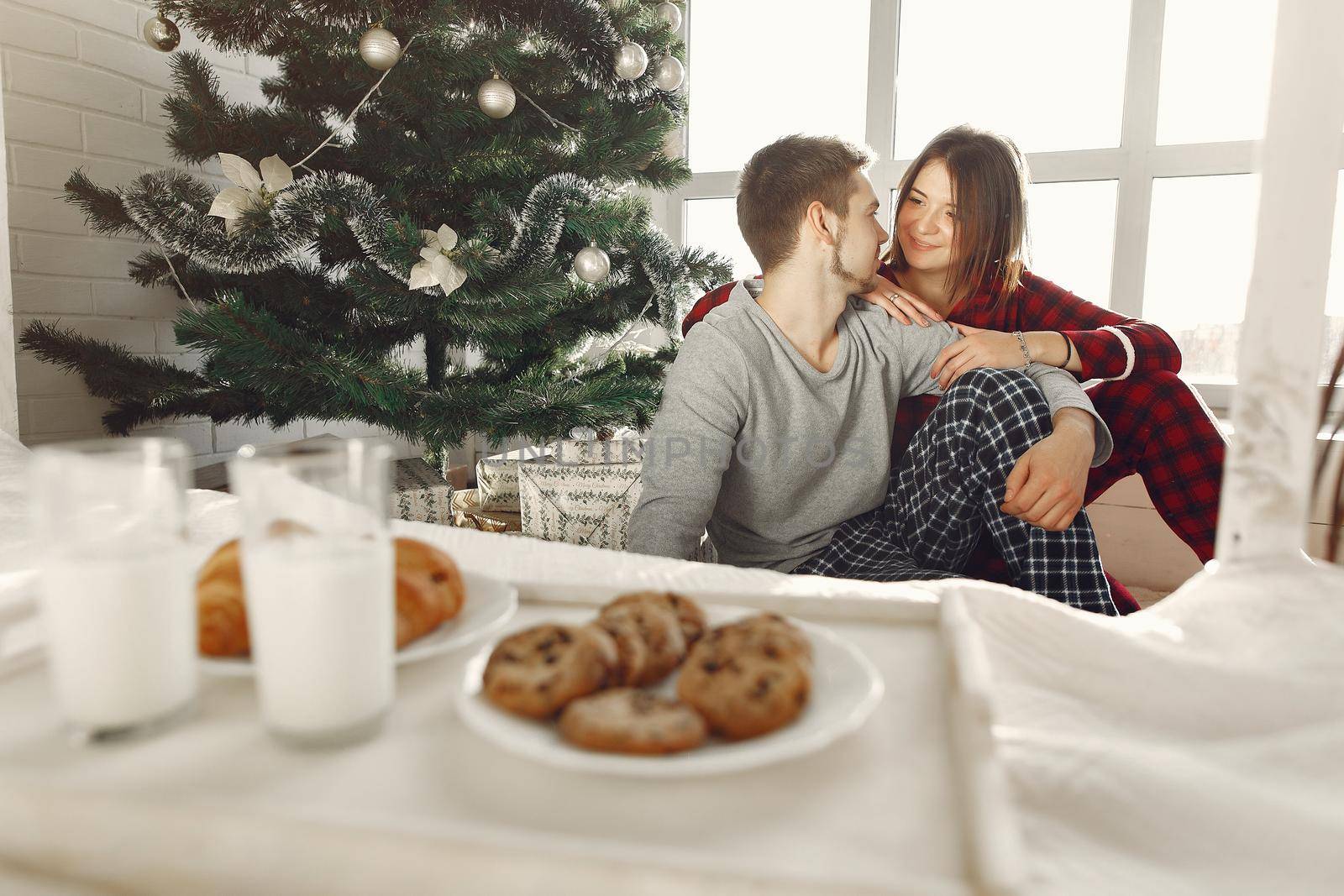 People at home. Family in a pajamas. Milk and croissants on a tray.