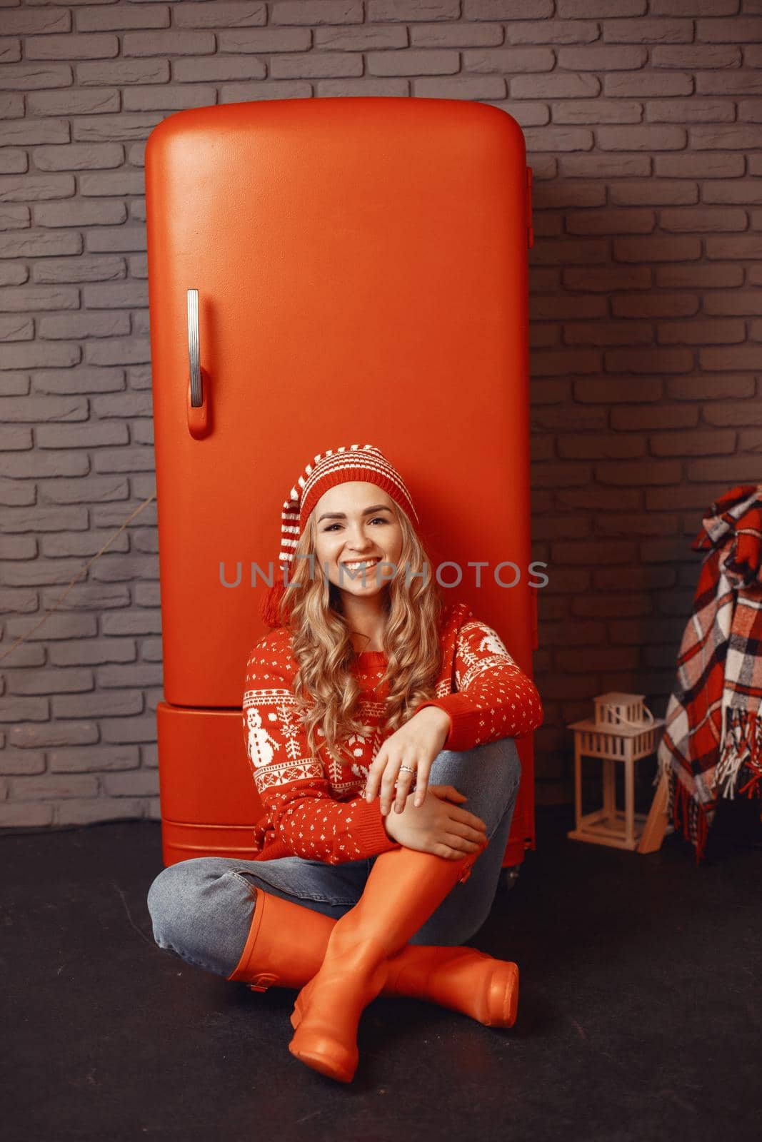 Woman in a white sweater. Lady look at the camera. Christmas concept. Woman in a kitchen.