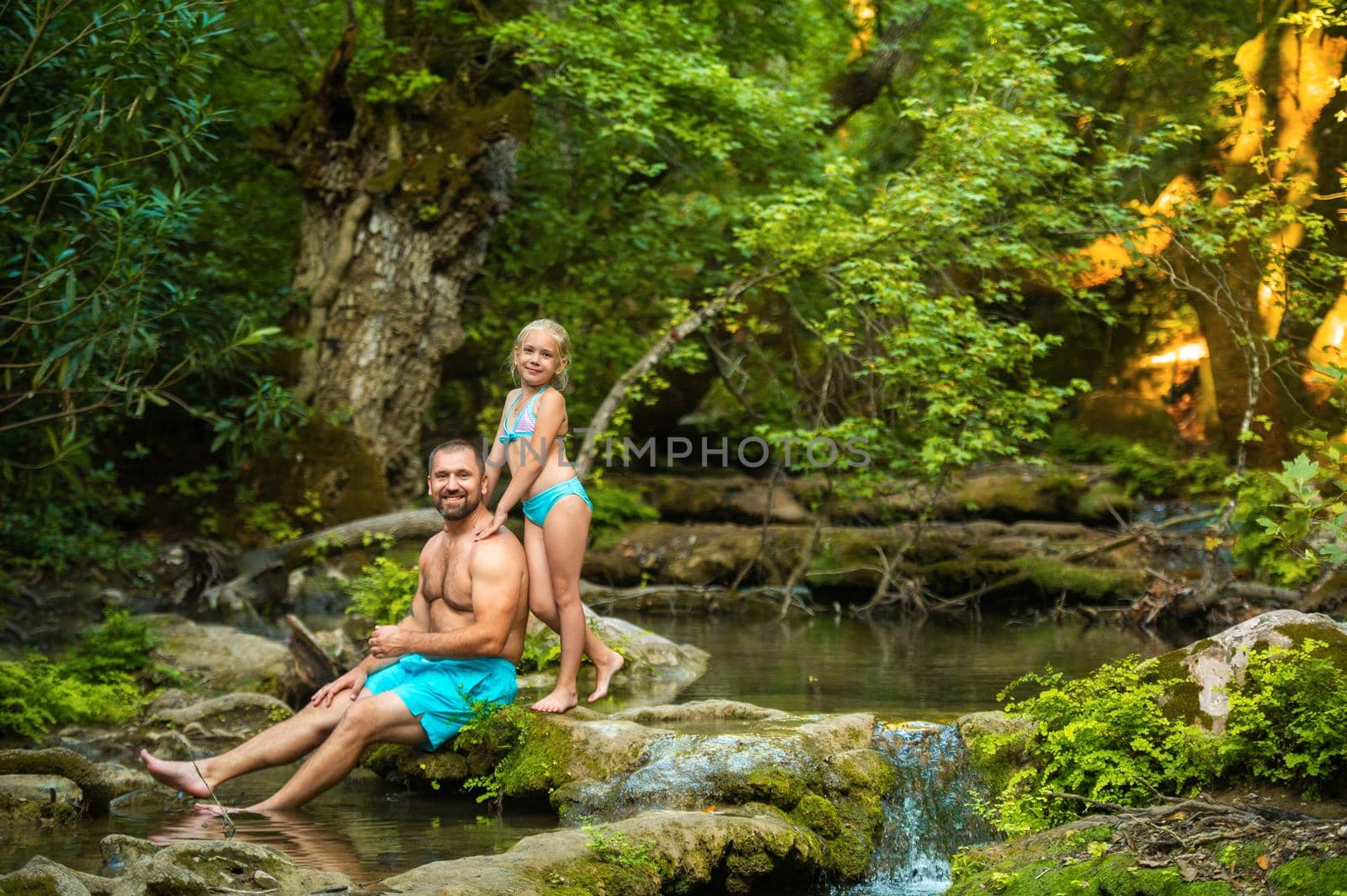 A father and daughter family on a mountain river in the jungle.Turkey by Lobachad