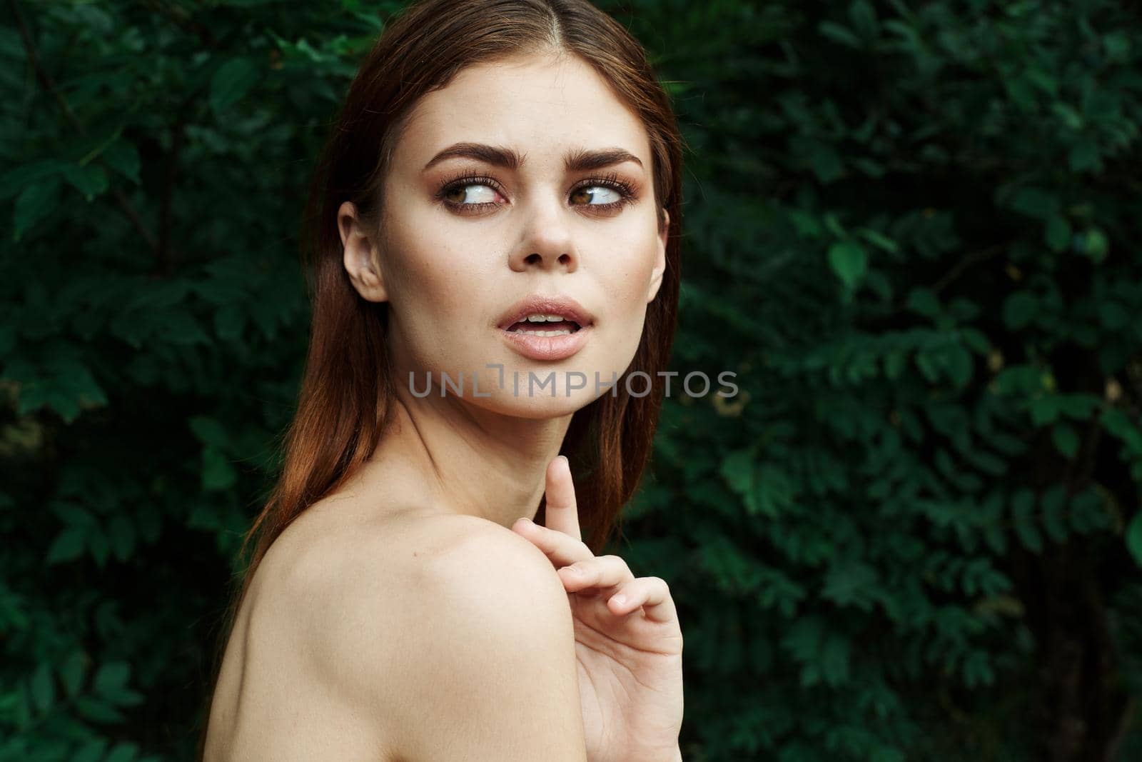 beautiful woman in a field outdoors bare shoulders clear skin close-up. High quality photo