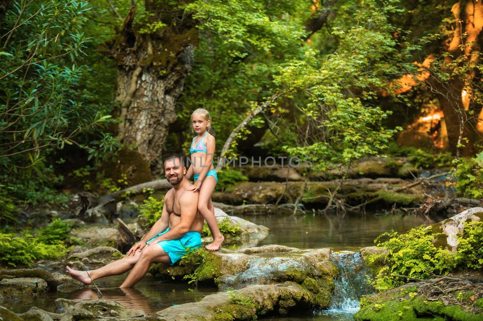 A father and daughter family on a mountain river in the jungle.Turkey.