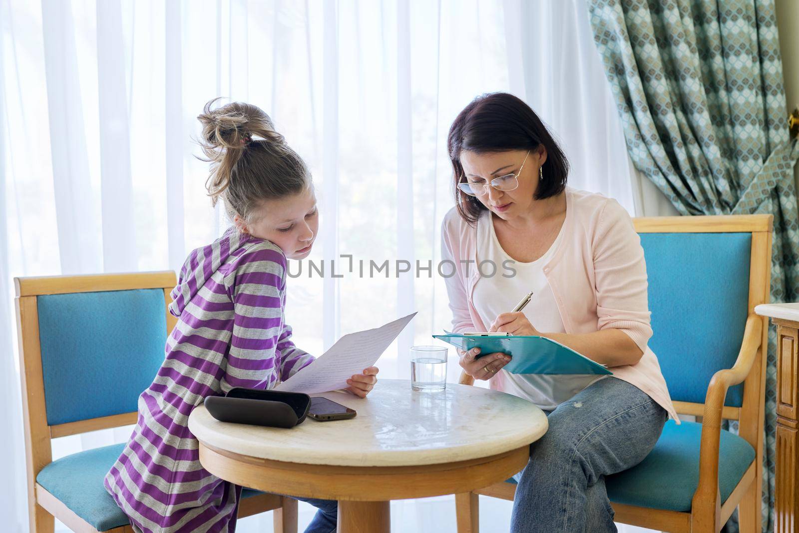 Pre-adolescent girl at consultation with therapist, social worker, counselor in office. Psychology, education, therapy, mental health, children concept