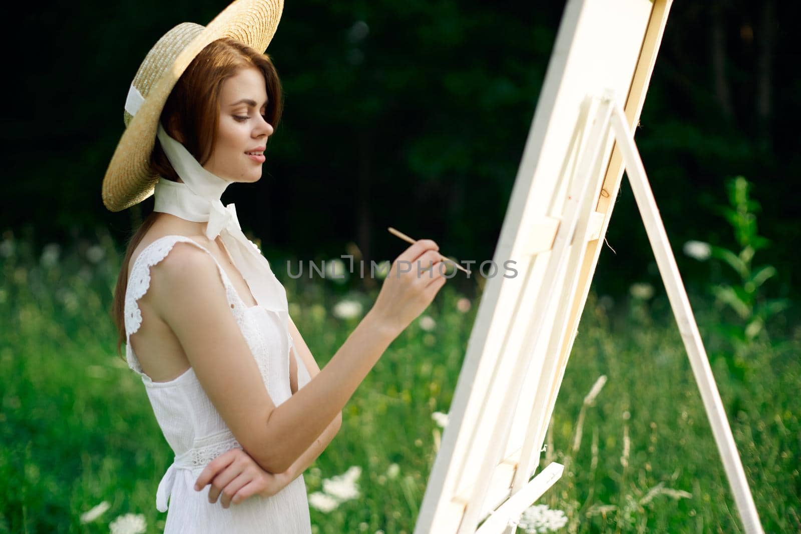 Woman in white dress artist hobby nature landscape. High quality photo