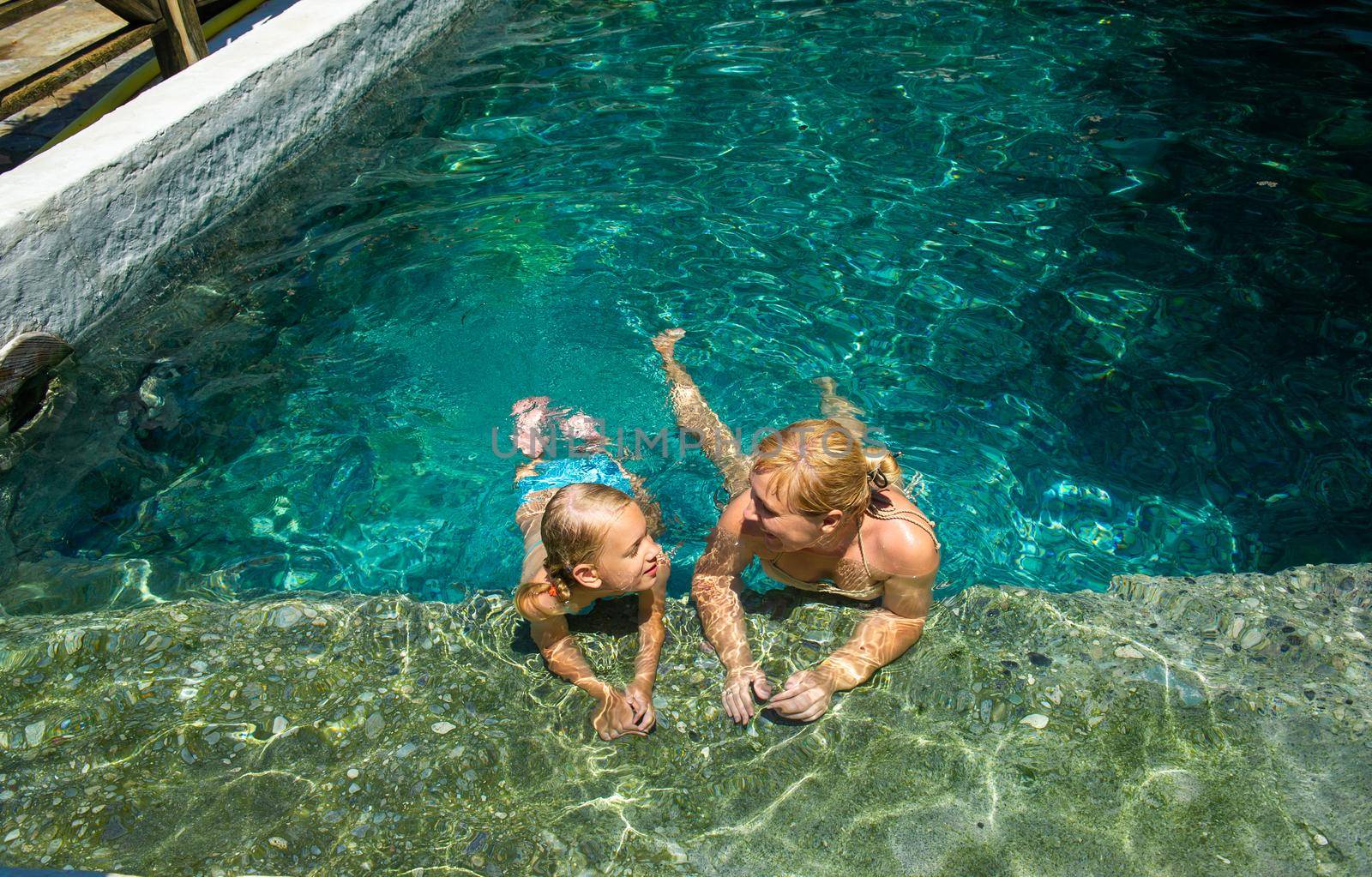 A happy family takes in a hydrogen sulfide treatment pool at a resort in Turkey.