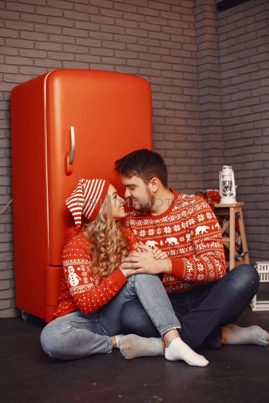 People in a Christman decorations. Man and woman in a red sweater. Family at home.