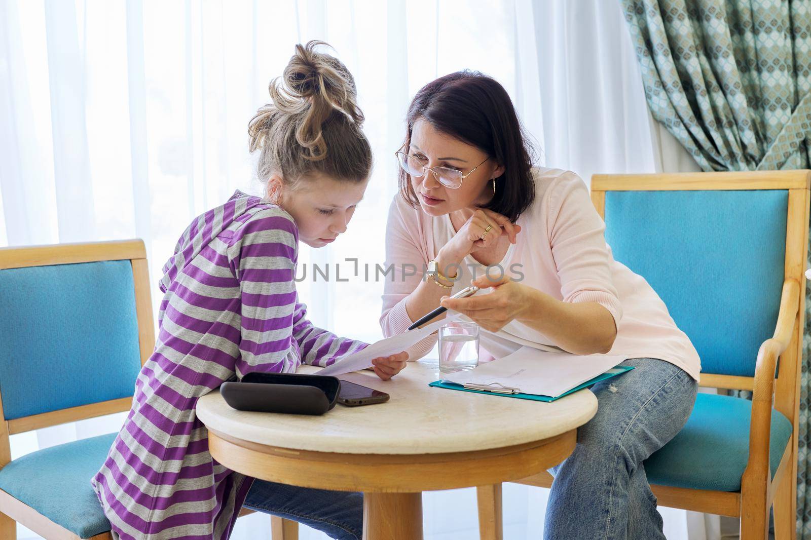 Pre-adolescent girl at consultation with social worker in office by VH-studio