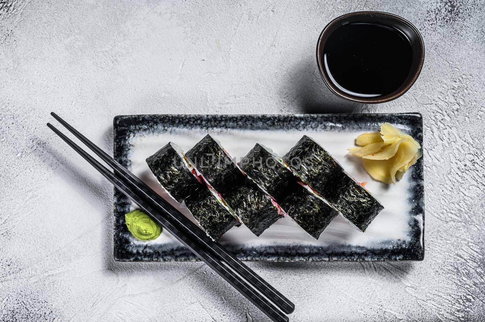 Sushi rolls hosomaki with salmon, avocado and tuna. Gray background. Top view.