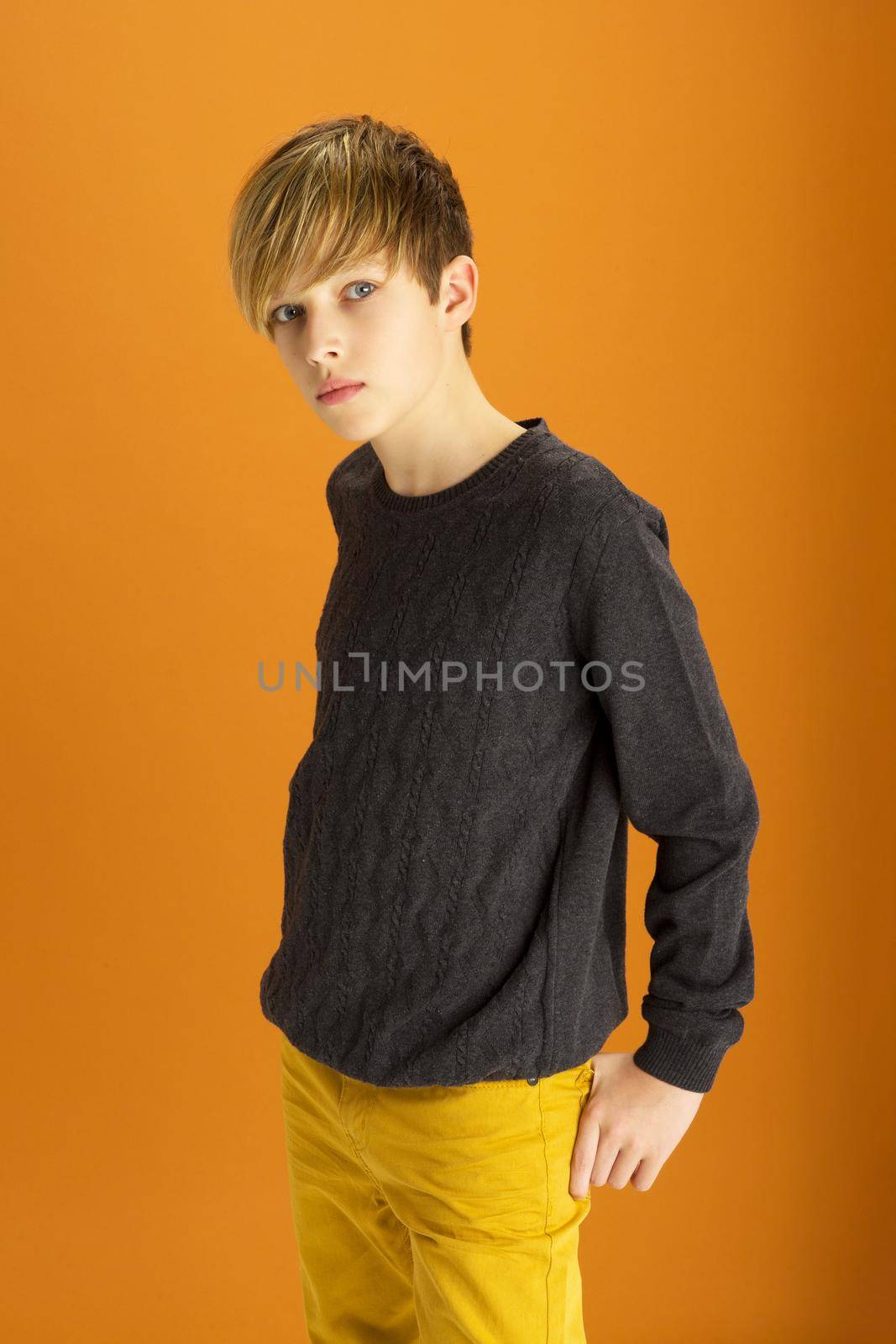 Stylish blond handsome teenage boy by kolesnikov_studio