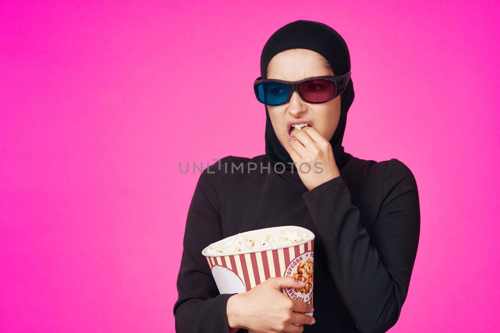 Muslim woman attractive look popcorn glasses movie watching isolated background. High quality photo