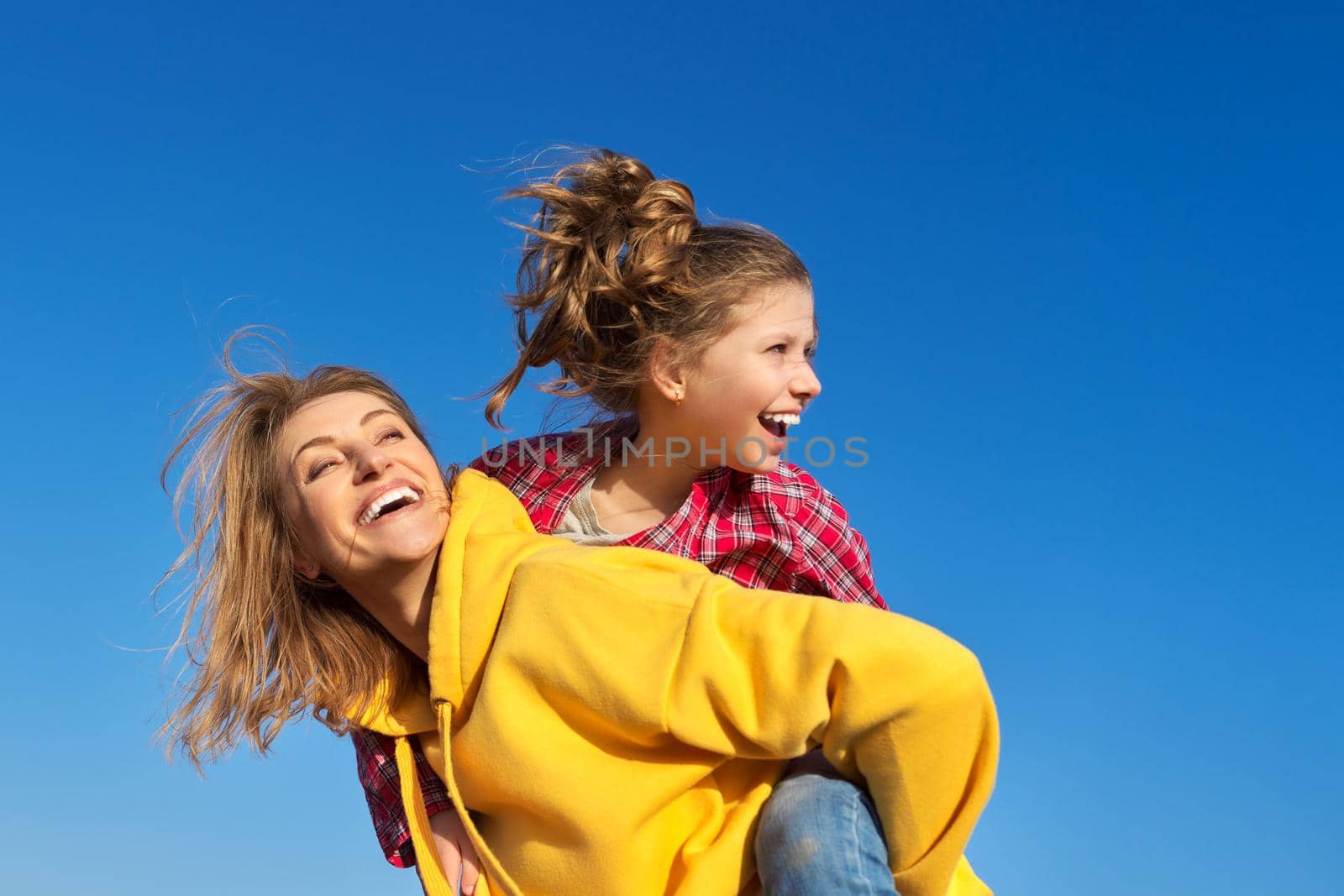 Happy mom and daughter child on seashore, relaxing on the sandy beach, autumn winter spring season by VH-studio