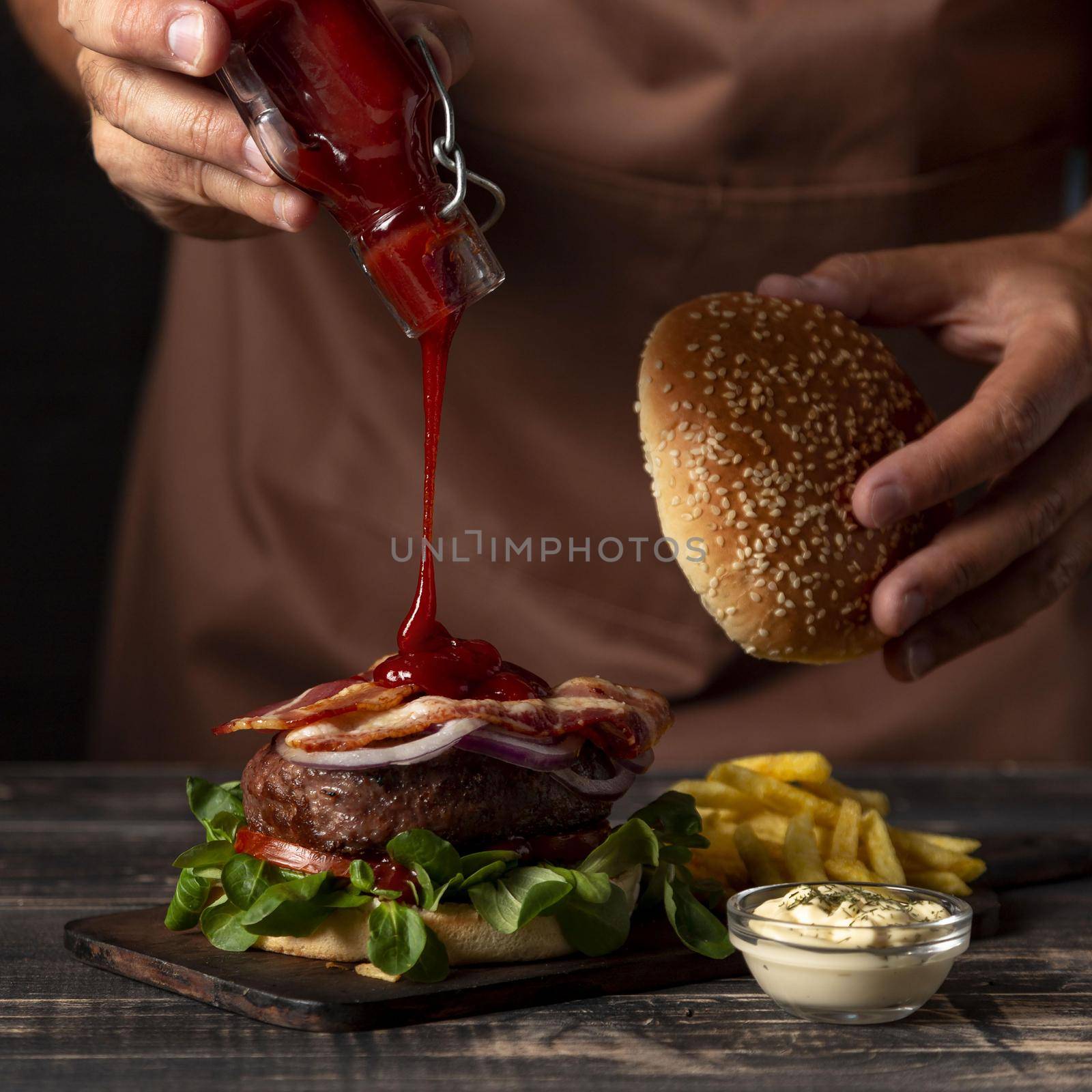 front view male putting sauce burger by Zahard