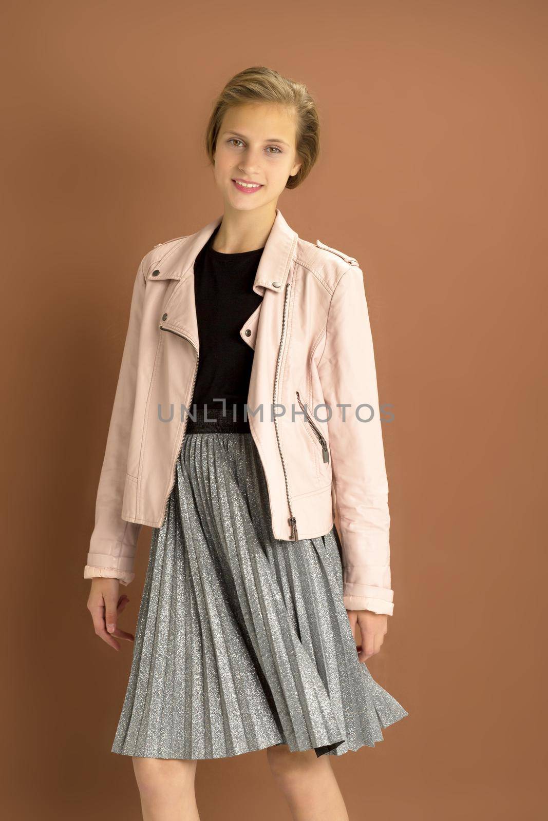 Happy girl whirling against brown background by kolesnikov_studio