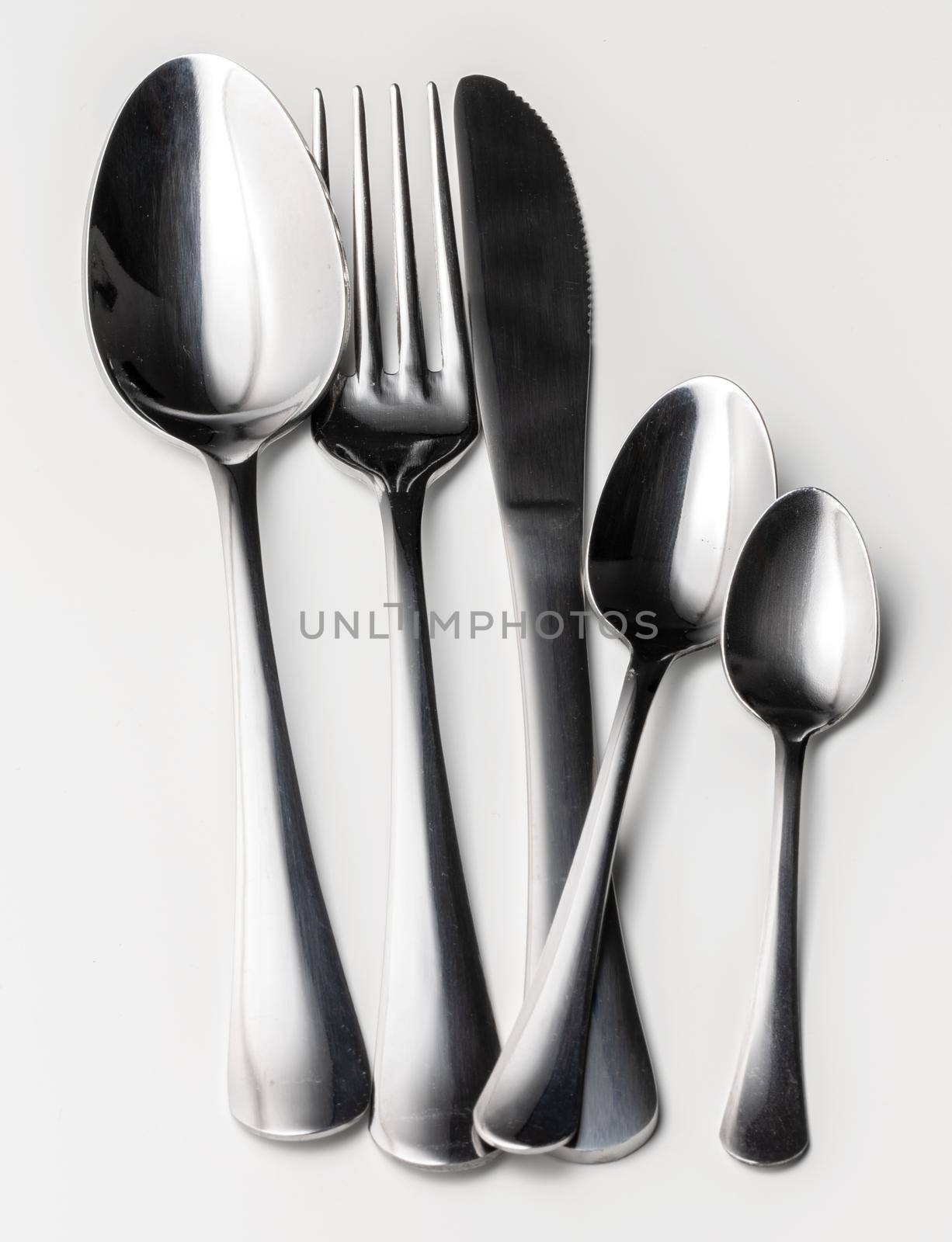 Set of silver cutlery on a white background. Close up.