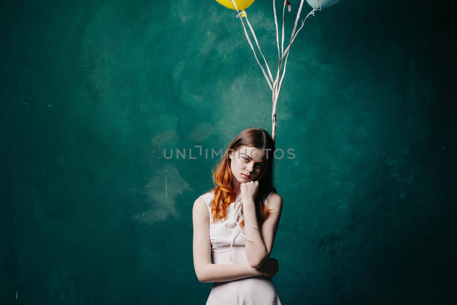 pretty woman in dress red balloon holiday green background. High quality photo