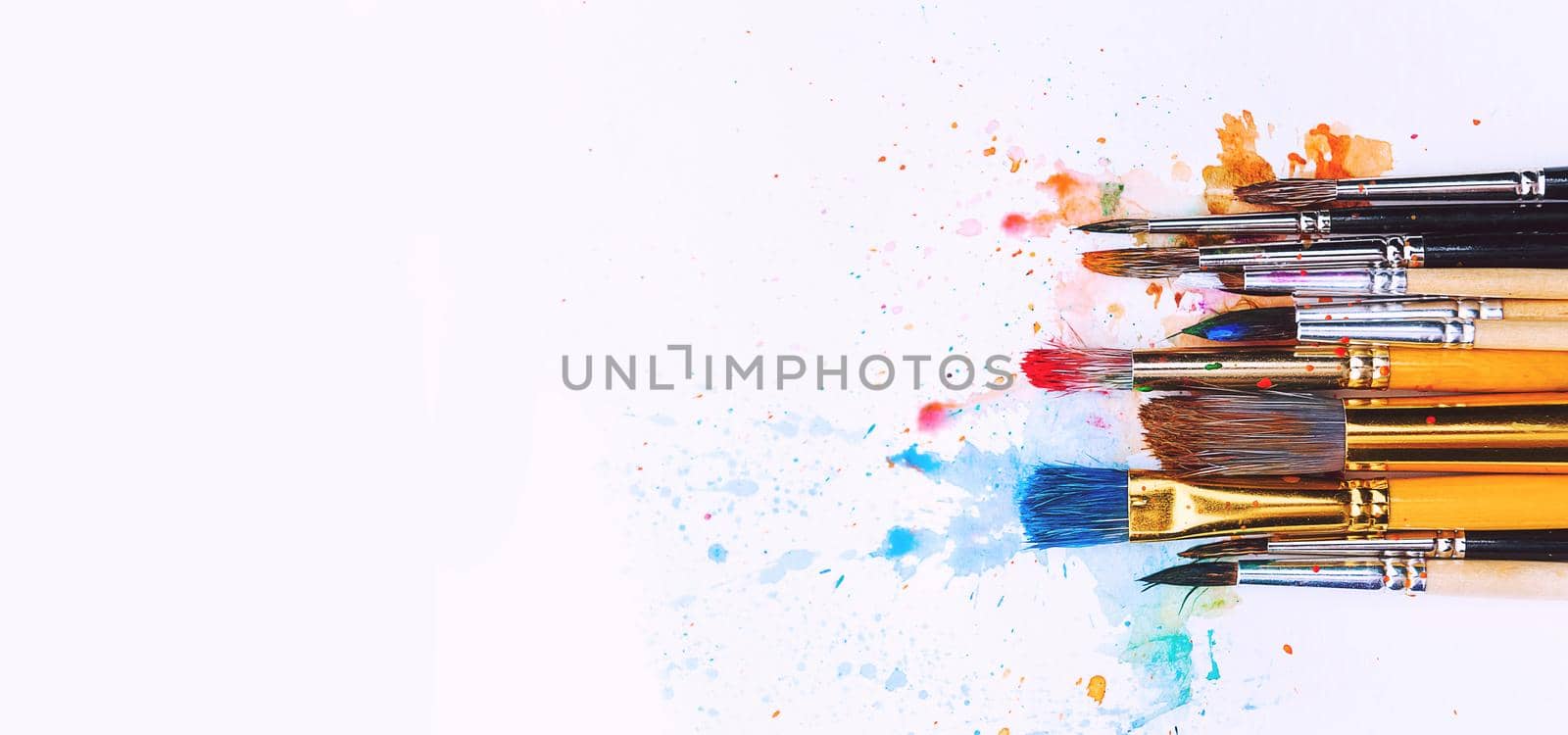 artistic brushes on wooden background by vvmich