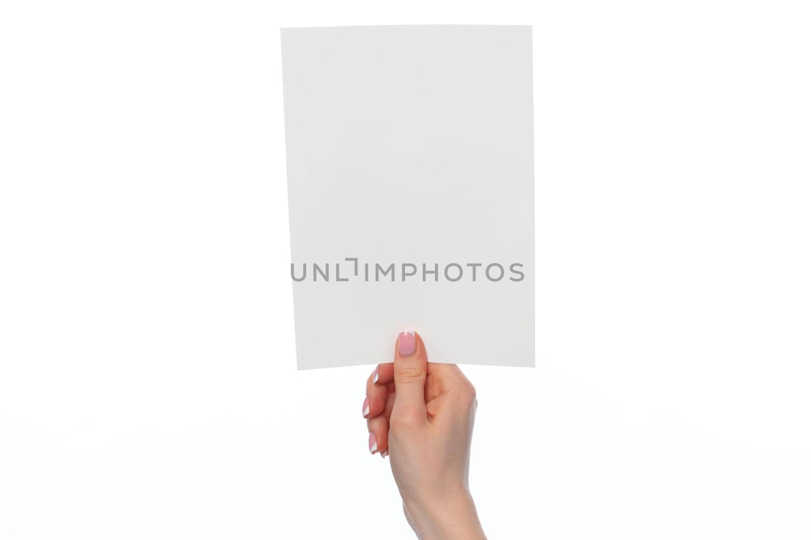 Female hand holding blank white sheet of paper isolated on white background