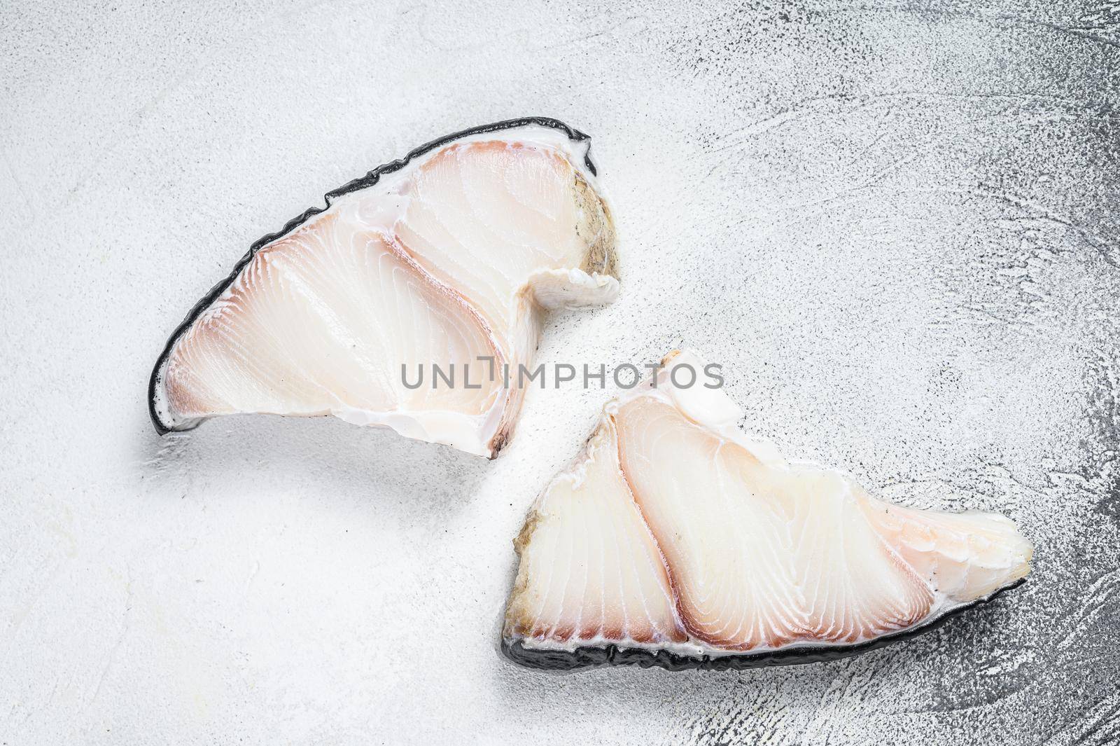 Raw Shark fish steaks on a kitchen table. White background. Top view.